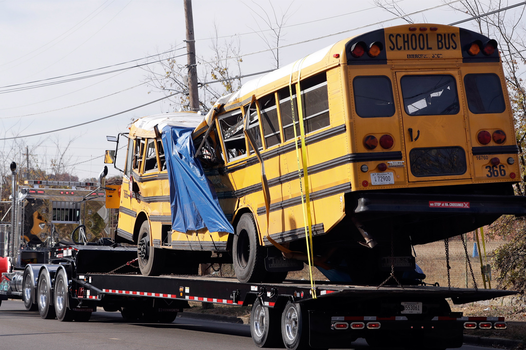 FILE- In this Nov. 22, 2016, file photo, a school bus is carried away in Chattanooga, Tenn., from the site where it crashed. Students and administrators raised concerns about a Tennessee school bus driver's behavior behind the wheel in the weeks...