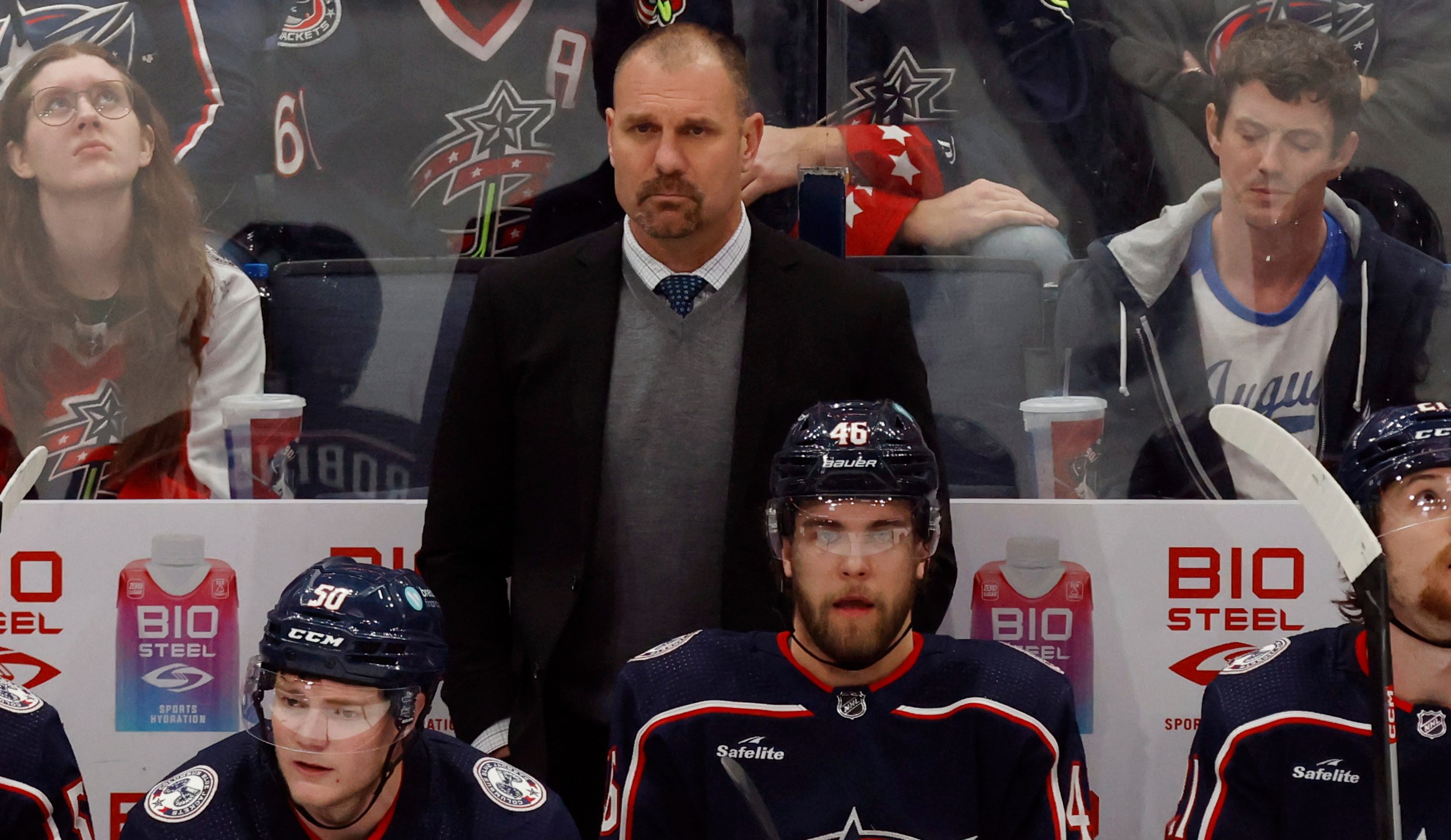 Columbus Blue Jackets coach Brad Larsen, center top, watches his team during the third period of an NHL hockey game against the Ottawa Senators in Columbus, Ohio, Sunday, April 2, 2023. (AP Photo/Paul Vernon)