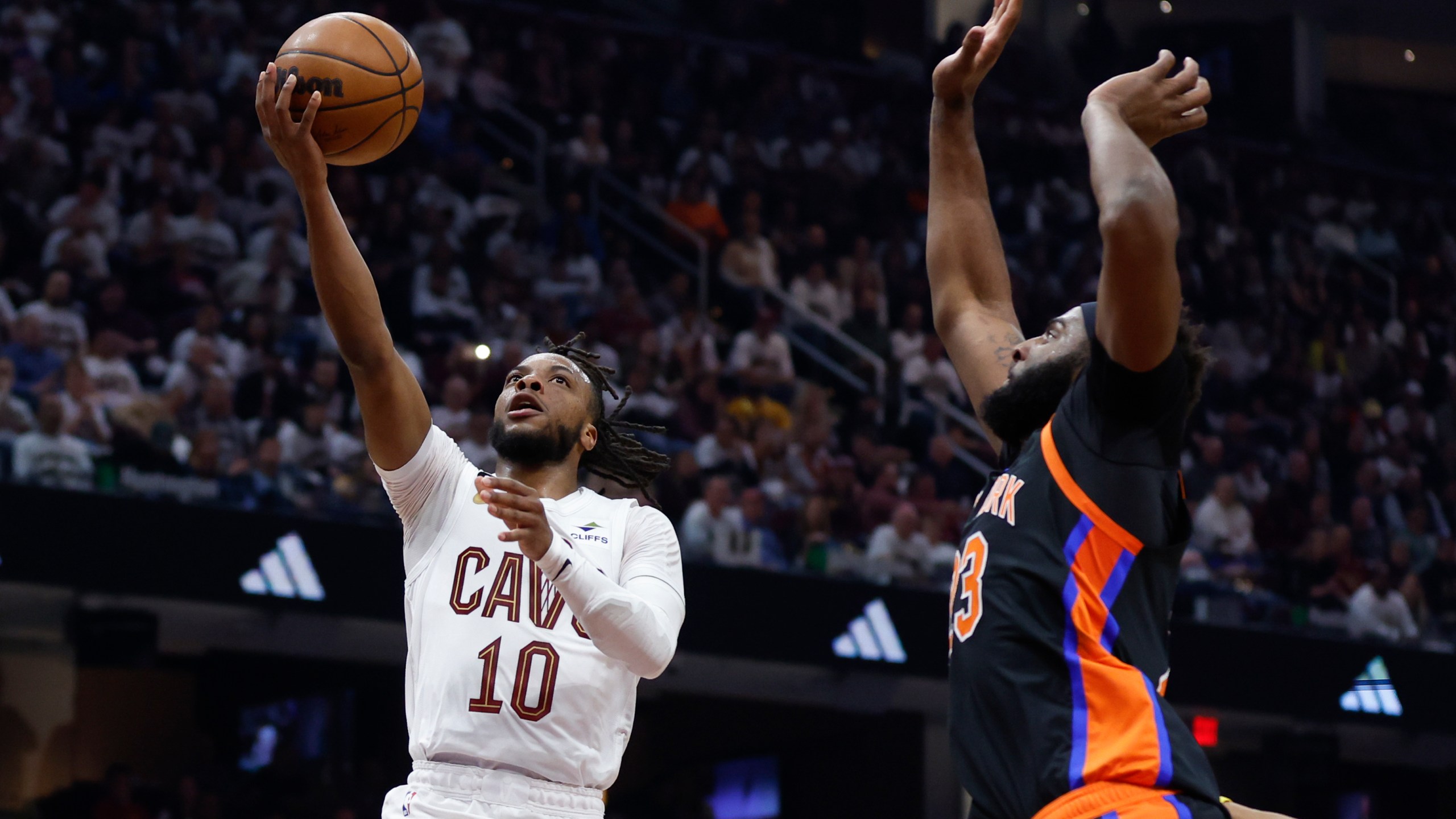Cleveland Cavaliers guard Darius Garland (10) shoots against New York Knicks center Mitchell Robinson during the first half of Game 2 of an NBA basketball first-round playoff series Tuesday, April 18, 2023, in Cleveland. (AP Photo/Ron Schwane)