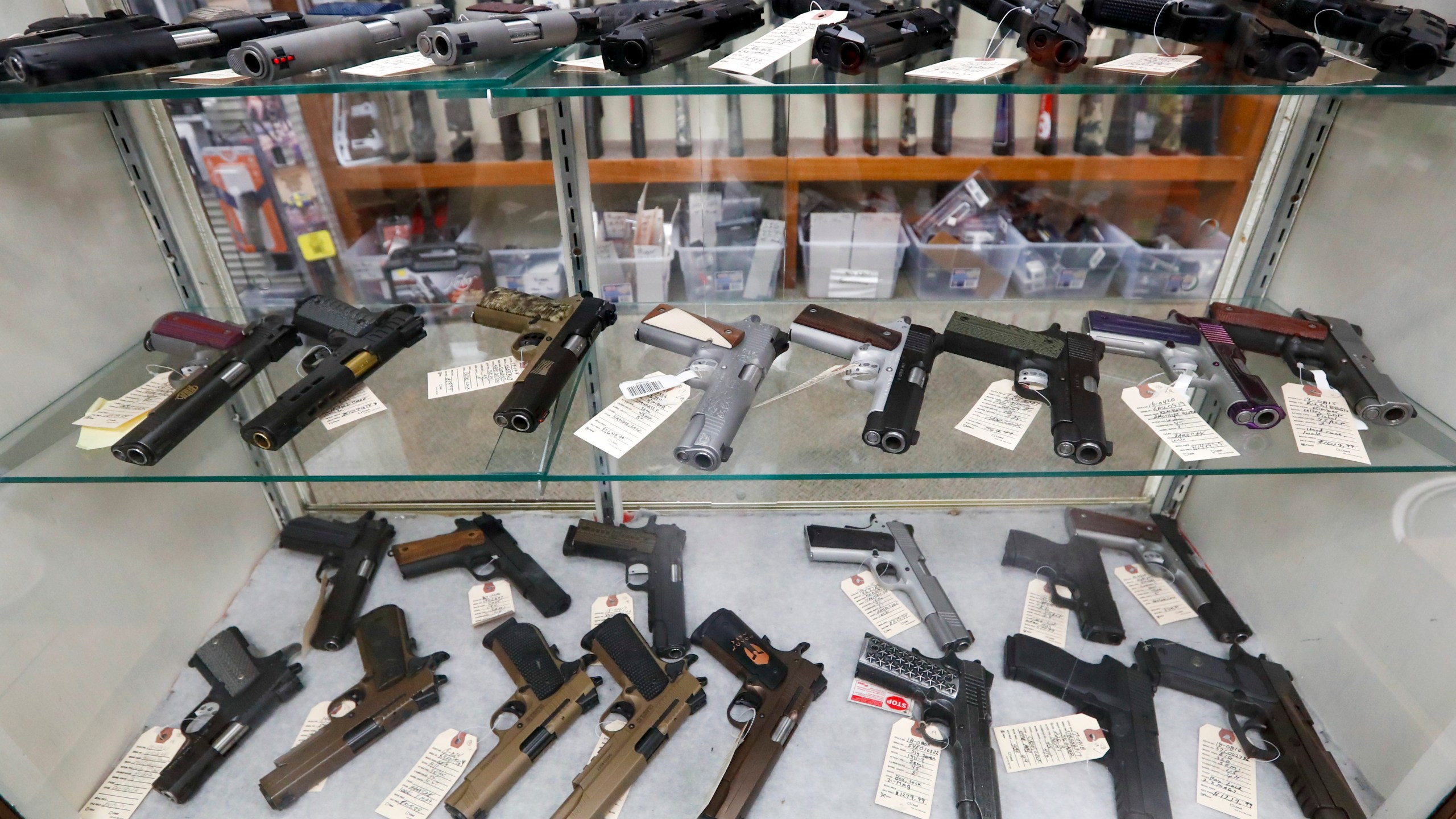 FILE - Semi-automatic handguns are displayed at shop in New Castle, Pa., March 25, 2020. A federal appeals court has dealt a legal setback to the Biden administration on guns in a lawsuit challenging tighter regulations on stabilizing braces, an accessory used in several mass shootings. The Fifth Circuit Court of Appeals temporarily blocked an administration rule from going into effect for the gun owners and groups who filed the lawsuit. The order came shortly before a deadline for people to register them and pay a fee, or remove the stabilizing braces from their weapons. (AP Photo/Keith Srakocic, File)
