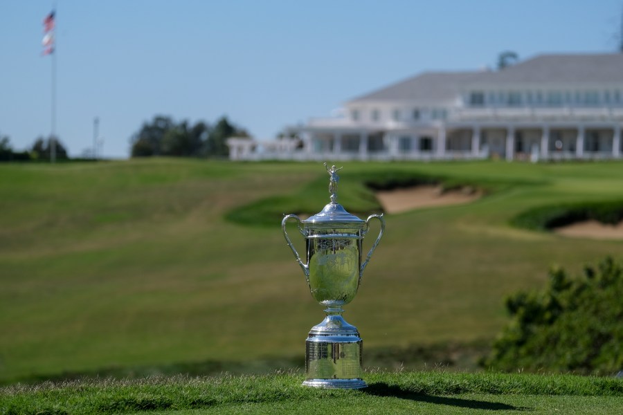 FILE - A U.S. Open Championship trophy is displayed at the ninth hole at Los Angeles Country Club on Sept. 26, 2022, in Los Angeles. The Los Angeles Country Club is opening itself to the world's largest golf audiences with the arrival of the 123rd U.S. Open next week. For its first century of existence, the club and its two courses were rarely seen by anyone except its wealthy members. (AP Photo/Ringo H.W. Chiu, File)