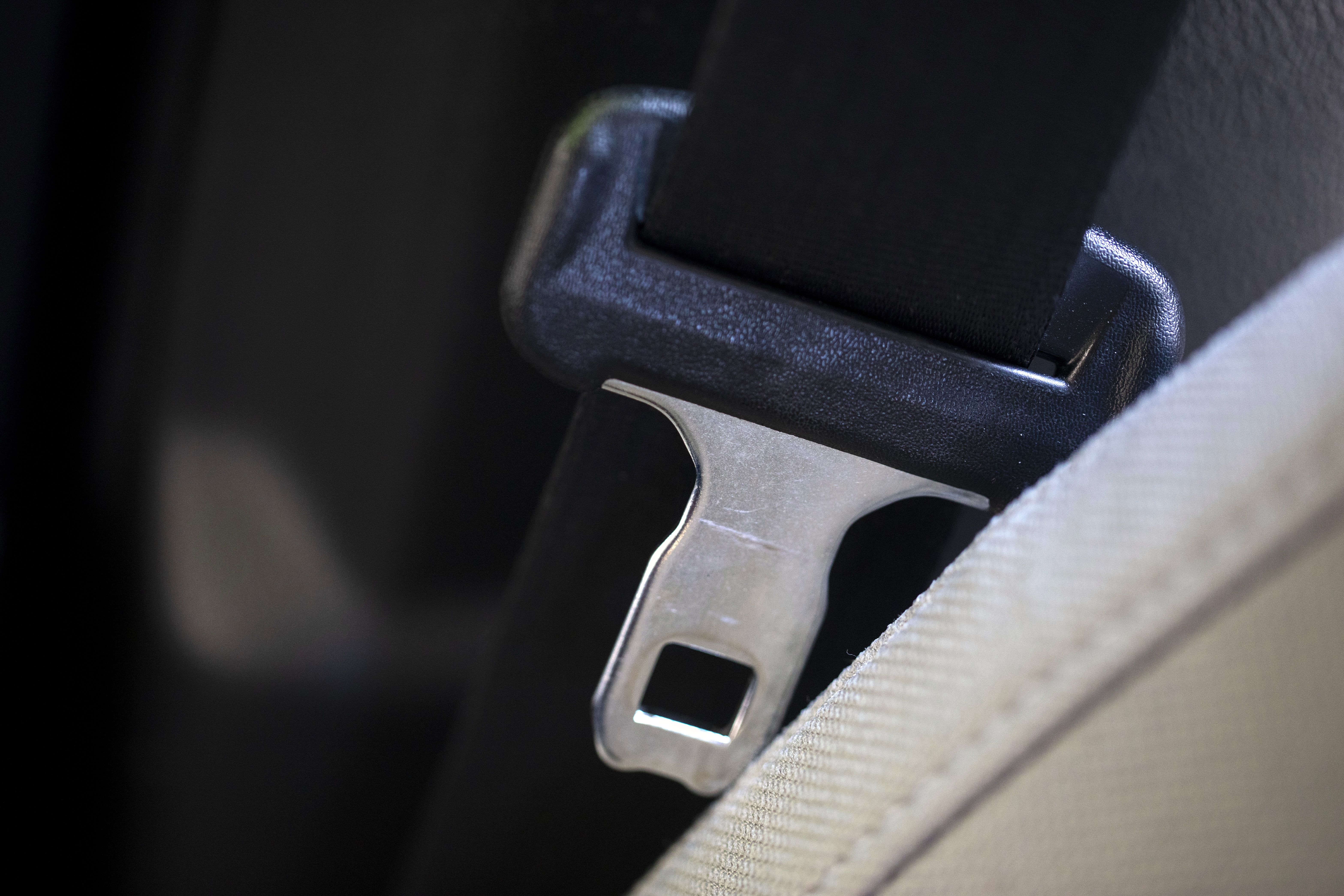 A seat belt for the right front passenger seat is shown in a vehicle on Monday, Aug. 21, 2023. The Department of Transportation is proposing new rules designed to encourage seat belt use by car and truck passengers, including those sitting in the back seat. The new rules proposed by the National Highway Traffic Safety Administration would require manufacturers to equip vehicles with additional seat belt warning systems for the right front passenger and for rear seats to encourage increased seat belt use. (AP Photo/Jenny Kane)