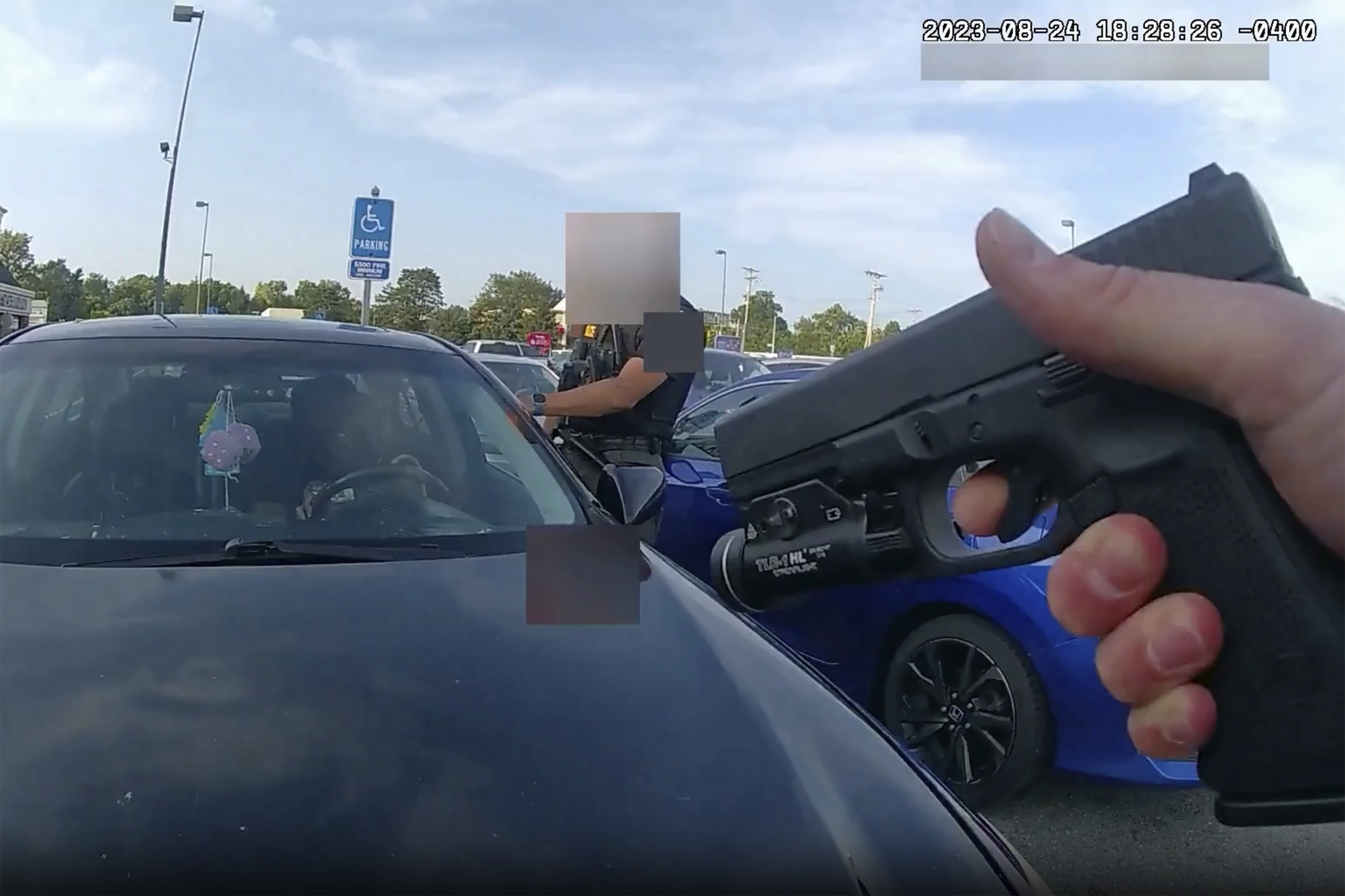 This still image from bodycam video released by the Blendon Township Police on Friday, Sept. 1, 2023, shows an officer pointing his gun at Ta’Kiya Young moments before shooting her through the windshield outside a grocery store in Blendon Township, Ohio, a suburb of Columbus, on Aug. 24. The pregnant Black mother was pronounced dead shortly after the shooting. Her unborn daughter did not survive. The video was pixelated by the source. (Blendon Township Police via AP)