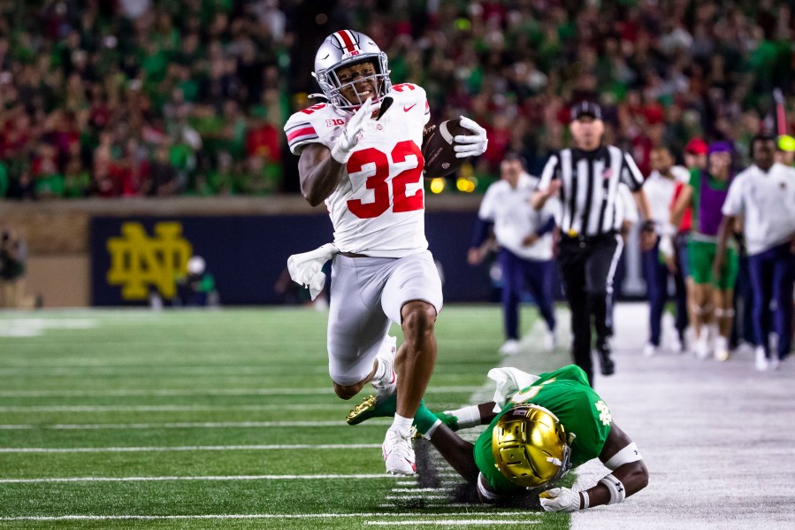 Ohio State running back TreVeyon Henderson (32) runs for a touchdown as Notre Dame safety DJ Brown falls behind him during the second half of an NCAA college football game Saturday, Sept. 23, 2023, in South Bend, Ind. (AP Photo/Michael Caterina)