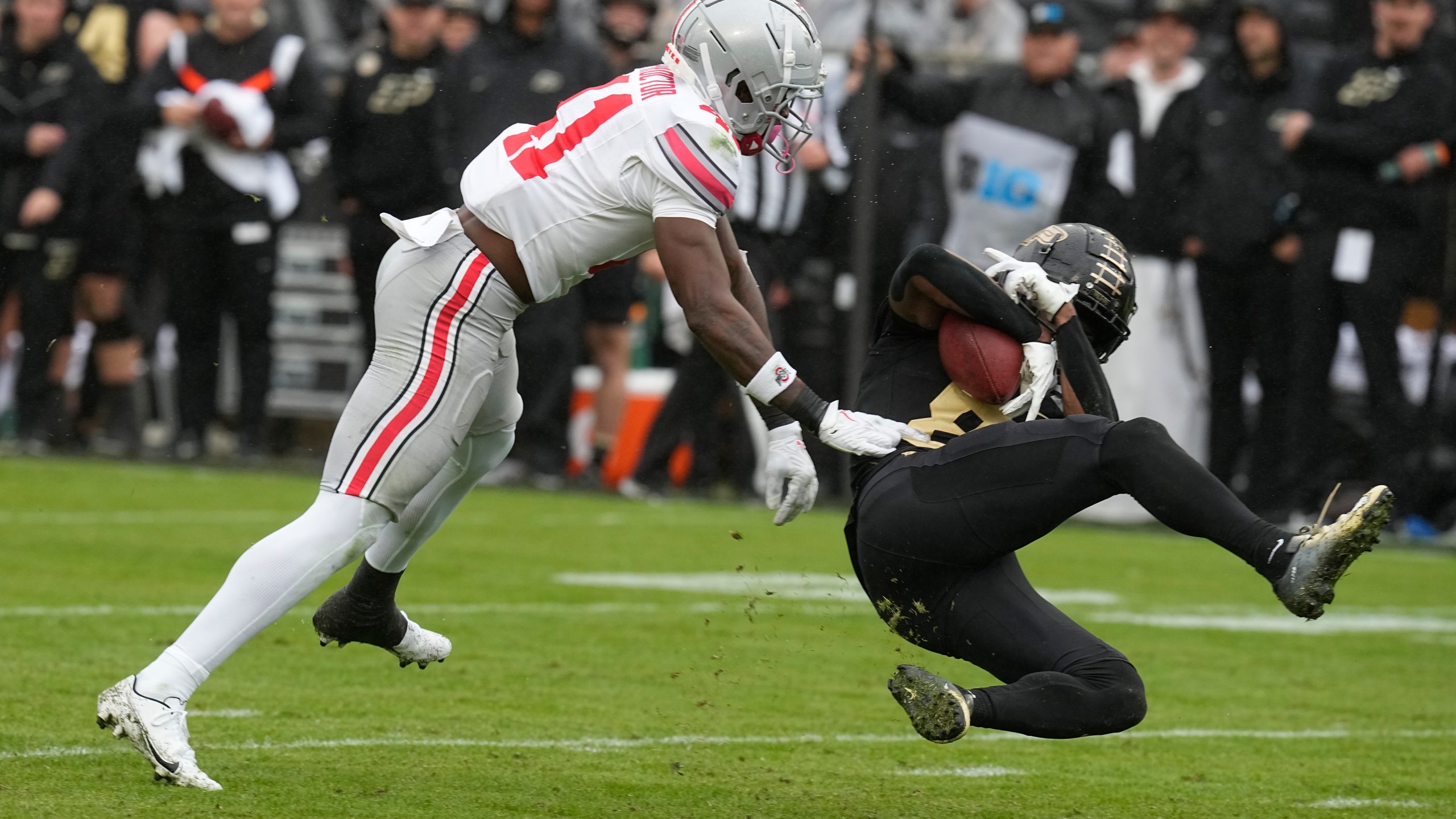 Purdue's TJ Sheffield (8) makes a catch against Ohio State's Josh Proctor (41) during the second half of an NCAA college football game, Saturday, Oct. 14, 2023, in West Lafayette, Ind. Ohio State won 41-7. (AP Photo/Darron Cummings)