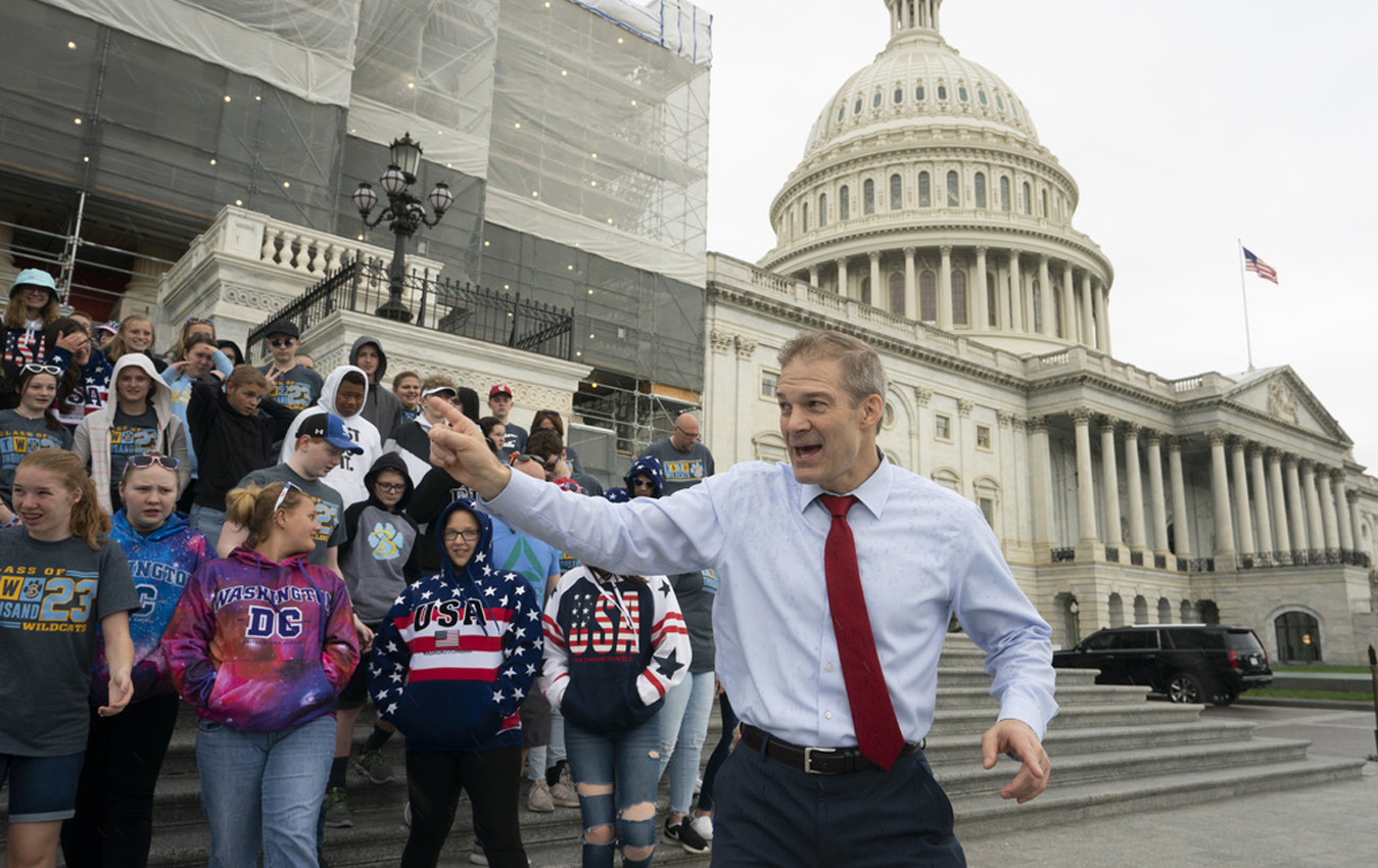 Rep. Jim Jordan, R-Ohio, greets 8th-grade students and parents from Bath Middle School of Lima, Ohio, as rain begins to fall on Capitol Hill in Washington, Friday, May 10, 2019. (AP Photo/J. Scott Applewhite, File)