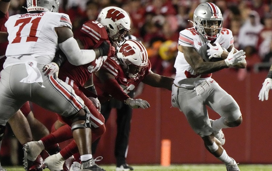 Ohio State's TreVeyon Henderson (32) runs during the first half of an NCAA college football game against Wisconsin Saturday, Oct. 28, 2023, in Madison, Wis. (AP Photo/Morry Gash)
