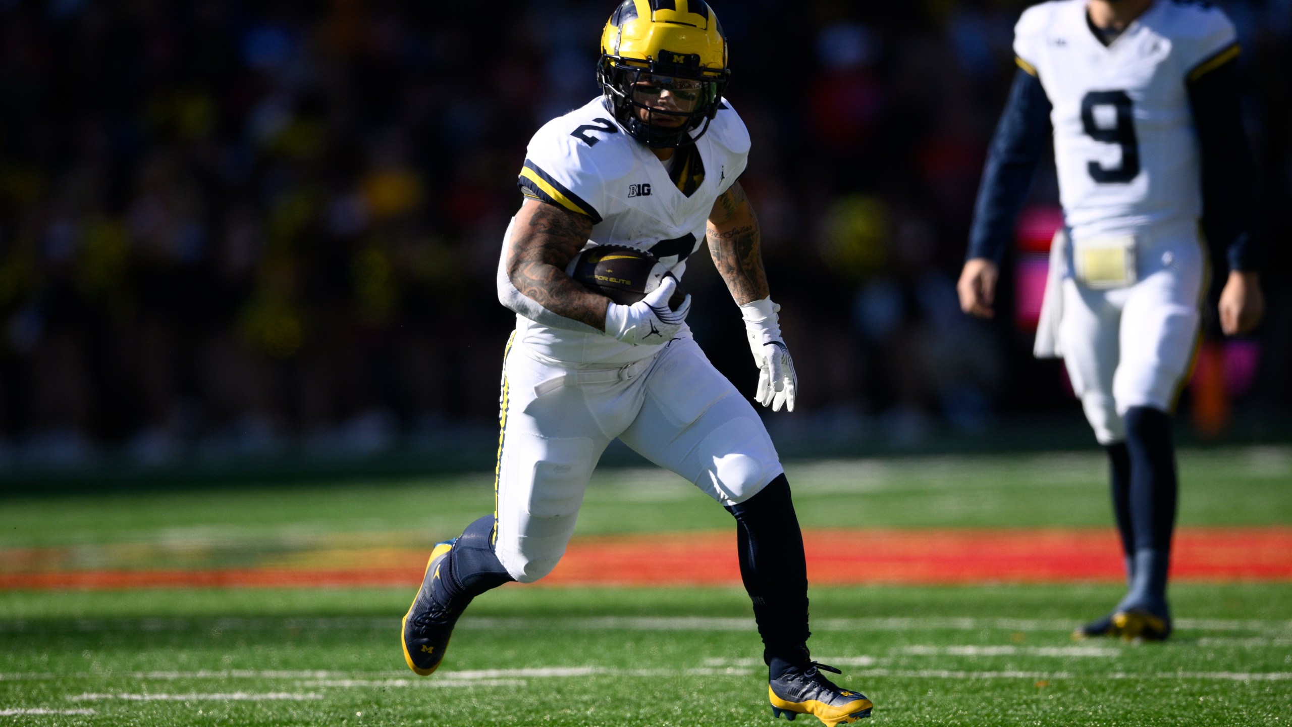 Michigan running back Blake Corum (2) runs with the ball during the first half of an NCAA college football game against Maryland, Saturday, Nov. 18, 2023, in College Park, Md. (AP Photo/Nick Wass)