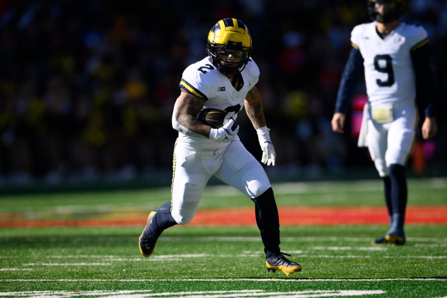 Michigan running back Blake Corum (2) runs with the ball during the first half of an NCAA college football game against Maryland, Saturday, Nov. 18, 2023, in College Park, Md. (AP Photo/Nick Wass)