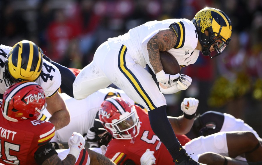 Michigan running back Blake Corum (2) runs in for a touchdown during the first half of an NCAA college football game against Maryland, Saturday, Nov. 18, 2023, in College Park, Md. (AP Photo/Nick Wass)