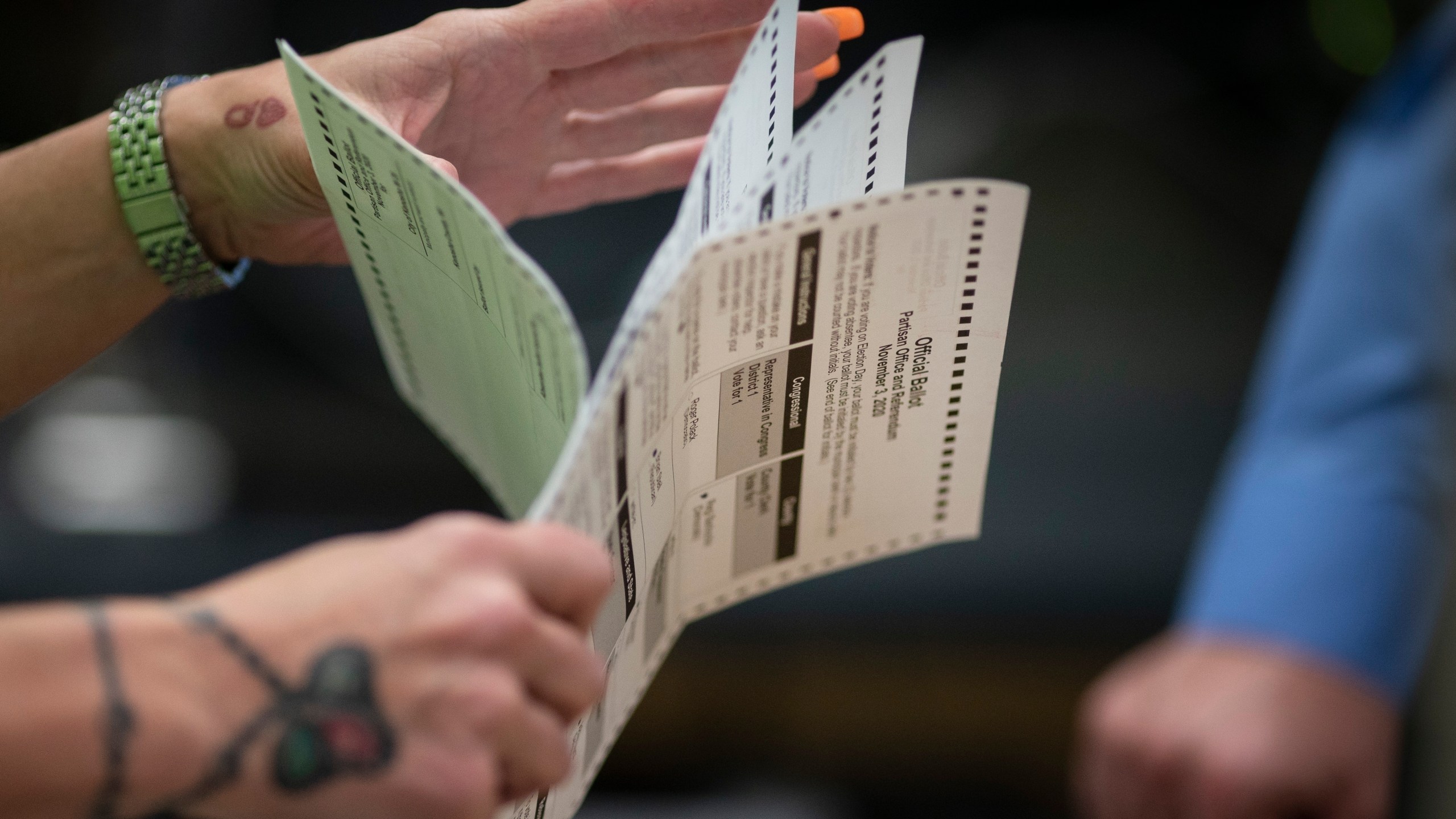 FILE - Poll workers sort out early and absentee ballots at the Kenosha Municipal building on Election Day in Kenosha, Wis., Nov. 3, 2020. A bipartisan bill that would dramatically change how Wisconsin residents choose congressional candidates by asking them to rank their top choices instead of voting for one of two candidates is headed for its first public hearing. (AP Photo/Wong Maye-E, File)