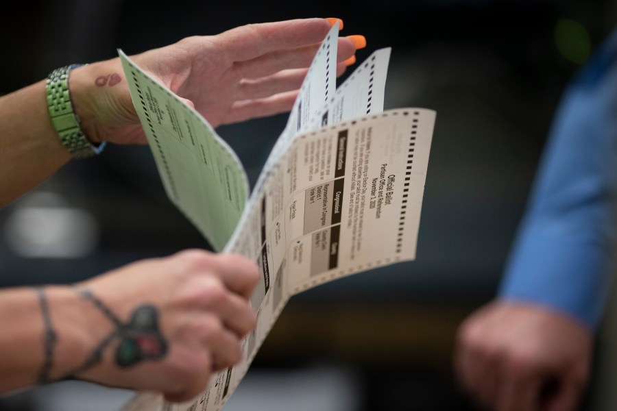FILE - Poll workers sort out early and absentee ballots at the Kenosha Municipal building on Election Day in Kenosha, Wis., Nov. 3, 2020. A bipartisan bill that would dramatically change how Wisconsin residents choose congressional candidates by asking them to rank their top choices instead of voting for one of two candidates is headed for its first public hearing. (AP Photo/Wong Maye-E, File)