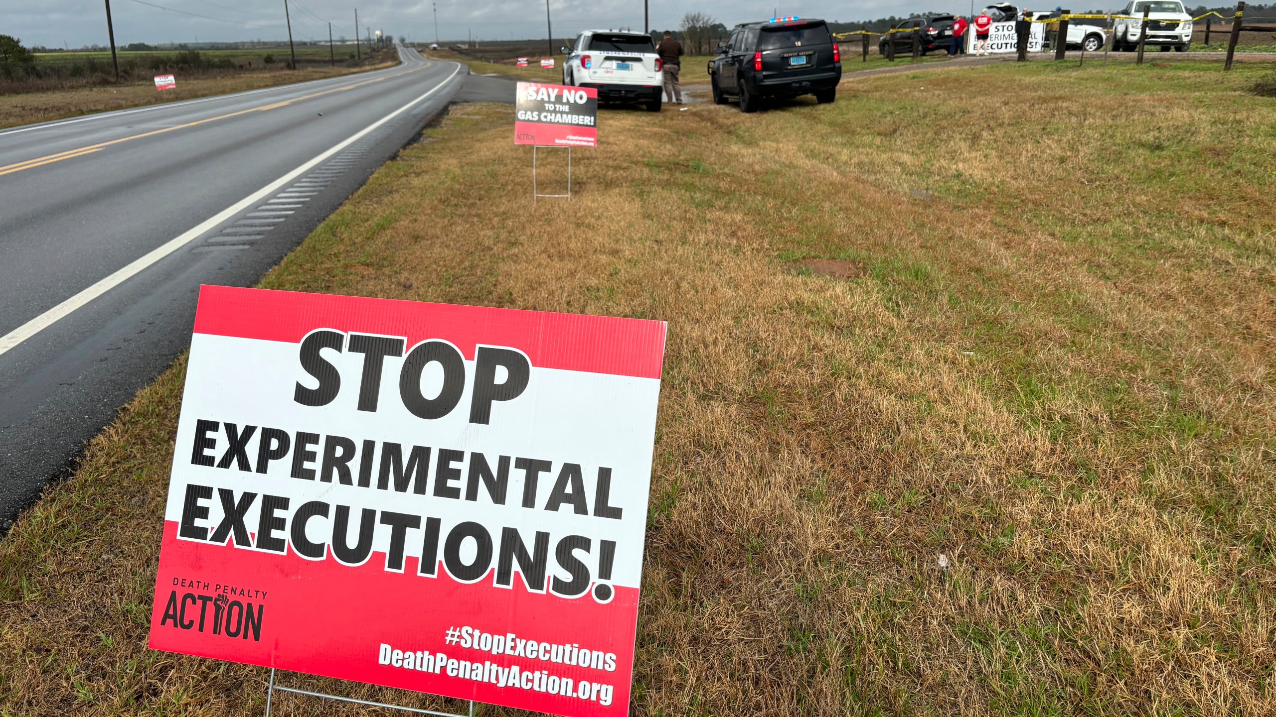 Anti-death penalty activists place signs along the road heading to Holman Correctional Facility in Atmore, Ala., ahead of the scheduled execution of Kenneth Eugene Smith on Thursday, Jan. 25, 2024. The state plans to put Smith to death with nitrogen gas, the first time the new method has been used in the United States. (AP Photo/Kim Chandler)