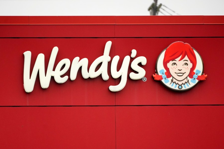 FILE - The Wendy's sign is seen at a restaurant, Jan. 23, 2023, in Pittsburgh. Wendy's is looking to test having the prices of its menu items fluctuate throughout the day based on demand, implementing a strategy that has already taken hold with ride-sharing companies and ticket sellers. (AP Photo/Gene J. Puskar, File)