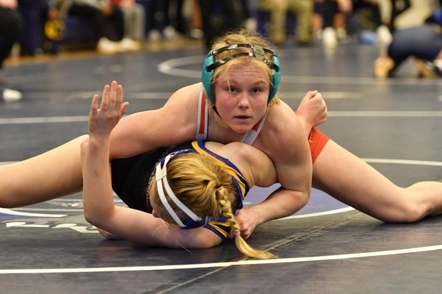 Easton Area High School wrestler Aubre Krazer, top, competes in a semifinal match during the Southeast Regional wrestling tournament Sunday, Feb. 25, 2024, in Quakertown, Pa. Girls’ wrestling has become the fastest-growing high school sport in the country. (AP Photo/Marc Levy)