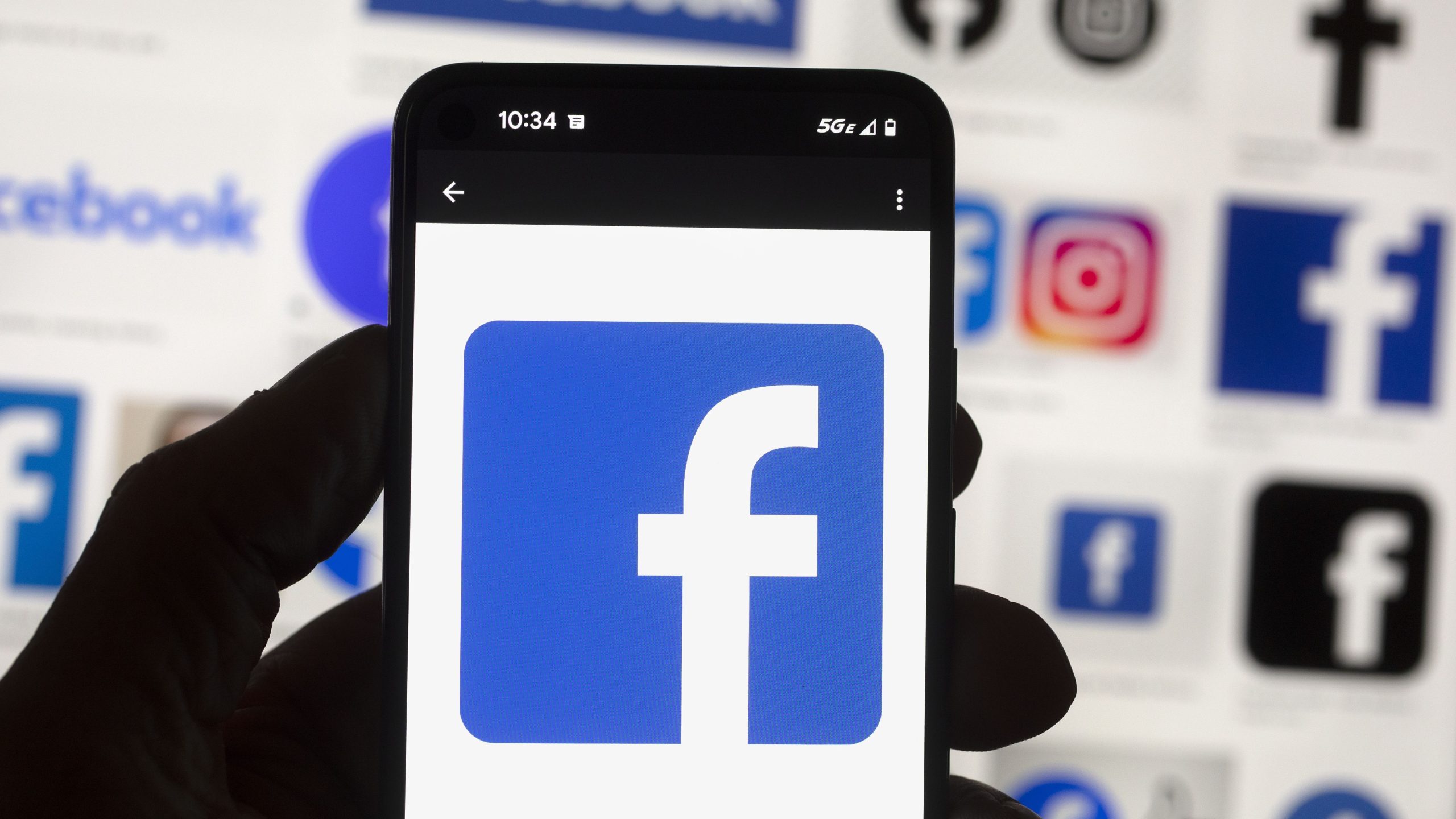 FILE - The Facebook logo is seen on a cell phone in Boston, USA, Oct. 14, 2022. The European Union said Tuesday April 30, 2024 that it's scrutinizing Facebook and Instagram over a range of suspected violations of the bloc's digital rulebook, including not doing enough to protect users from foreign disinformation ahead of EU-wide elections. (AP Photo/Michael Dwyer, File)