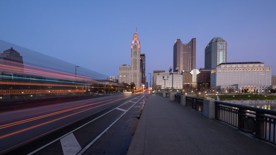 Evening Columbus Ohio skyline along the Scioto River at dusk with car trails