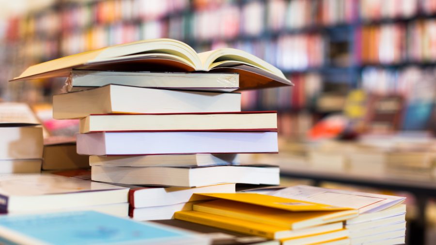 stack of art books lying on table in bookstore
