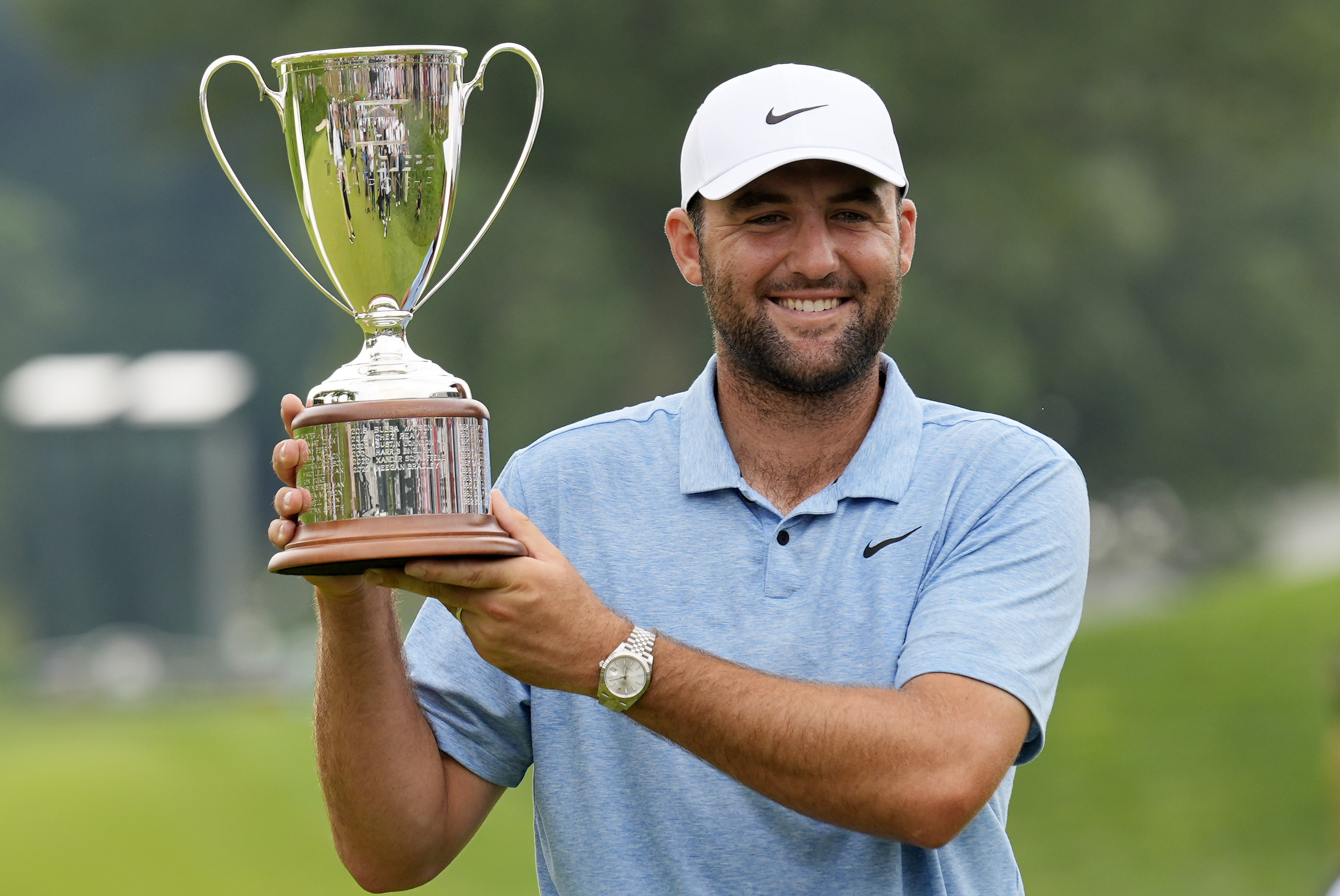 Scottie Scheffler holds up his trophy after winning the Travelers Championship golf tournament at TPC River Highlands, Sunday, June 23, 2024, in Cromwell, Conn. (AP Photo/Seth Wenig)