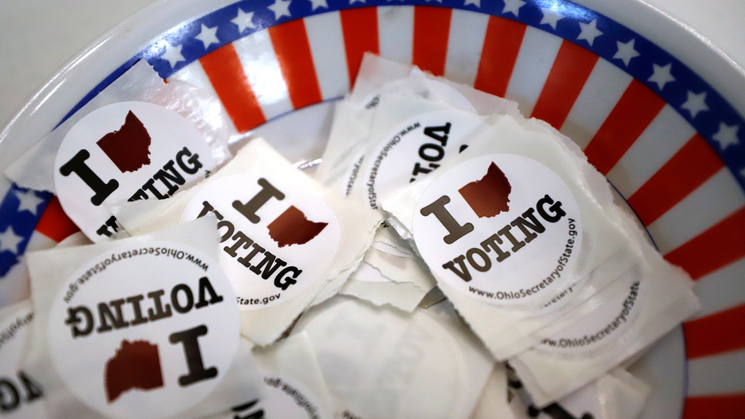 FILE - A is a bowl of voting stickers for early voters is shown March 15, 2020, in Steubenville, Ohio. A federal judge struck down restrictions Monday, July 22, 2024, in Ohio’s sweeping 2023 election law that voting rights groups said restricted people from helping voters with disabilities cast absentee ballots. (AP Photo/Gene J. Puskar, File)