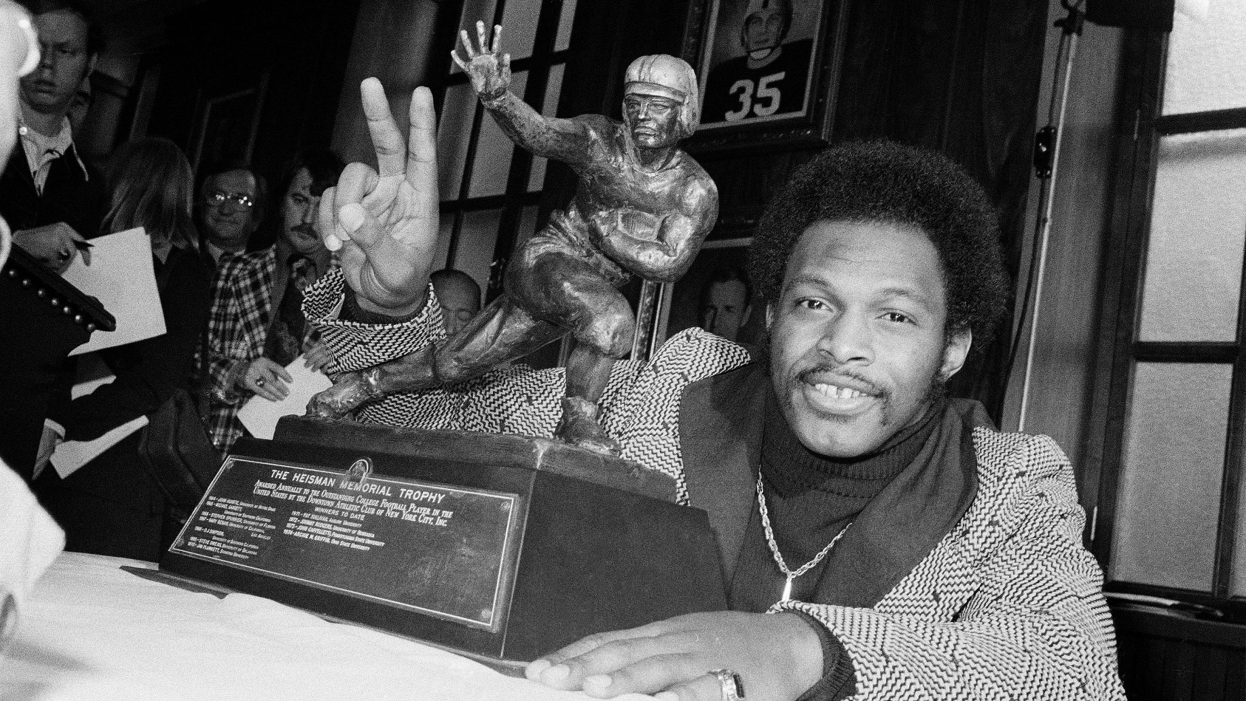 Ohio State's running back Archie Griffin smiles as he poses with the 1975 Heisman Trophy, on December 2, 1975, in New York City. Griffin, who already won in 1974, is the first player to win the prestigious award twice. (AP Photo)