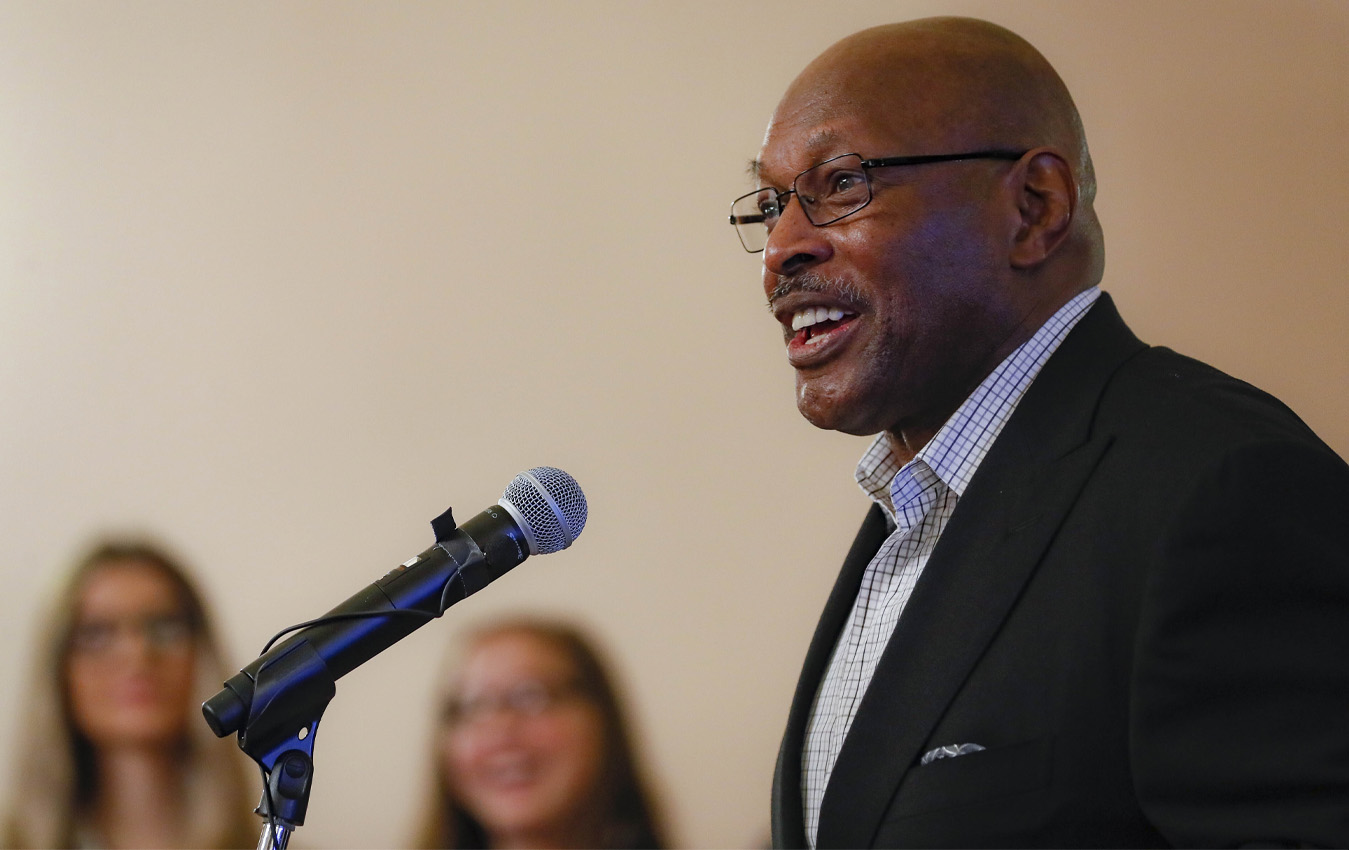 Two-time Heisman Trophy winner Archie Griffin speaks before James "Buster" Douglas during a news conference at the Ohio Statehouse to announce the "42 to 1" initiative, Wednesday, Oct. 30, 2019, in Columbus, Ohio. Douglas is marking the 30th anniversary of his upset boxing victory over Mike Tyson with a campaign aimed to inspiring others who face long odds. (AP Photo/John Minchillo)