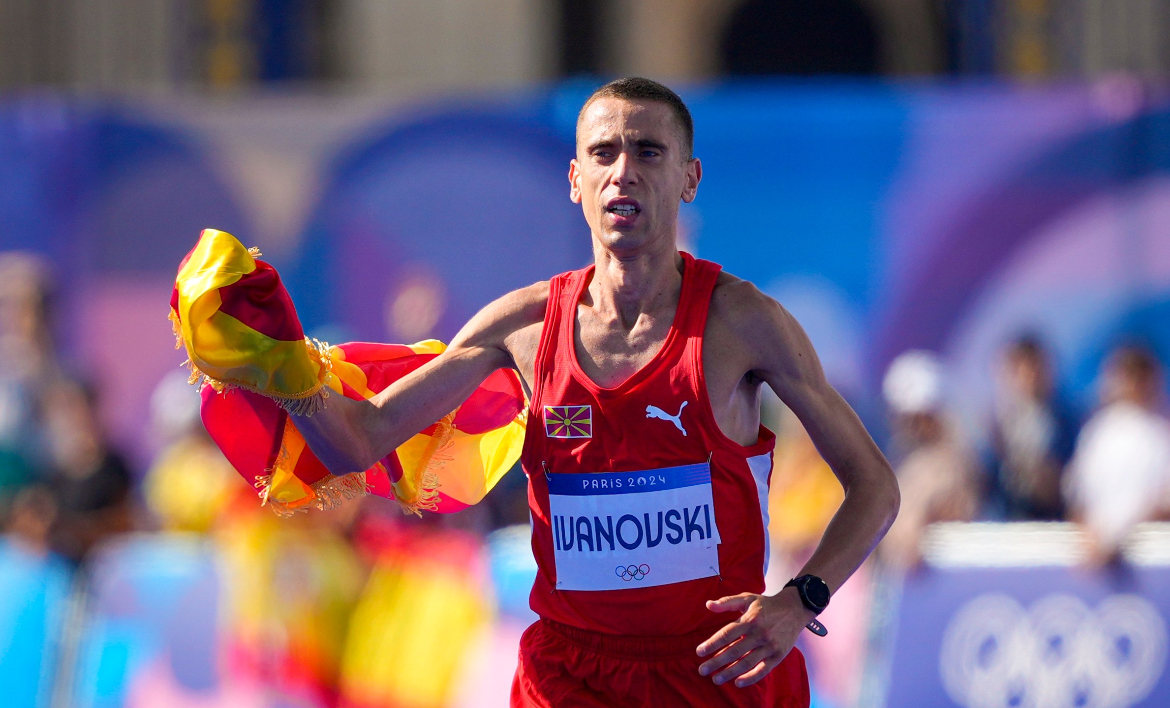 North Macedonia's Dario Ivanovski celebrates after crossing the finish line at the end of the men's marathon competition at the 2024 Summer Olympics, Saturday, Aug. 10, 2024, in Paris, France. (AP Photo/Dar Yasin)