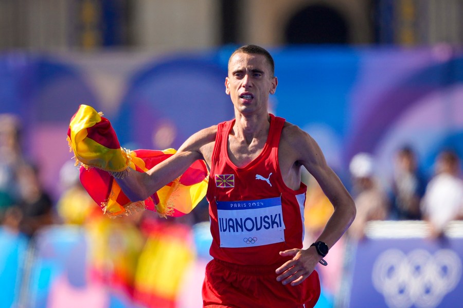 North Macedonia's Dario Ivanovski celebrates after crossing the finish line at the end of the men's marathon competition at the 2024 Summer Olympics, Saturday, Aug. 10, 2024, in Paris, France. (AP Photo/Dar Yasin)