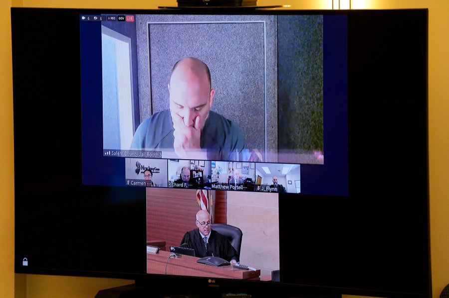 Sean M. Higgins, top, the alleged drunken driver charged with killing NHL hockey player Johnny Gaudreau and his brother Matthew as they bicycled on a rural road, appears before Judge Michael Silvanio, for his hearing via video from jail, Friday, Sept. 13, 2024, in Woodbury, N.J. (AP Photo/Derik Hamilton)