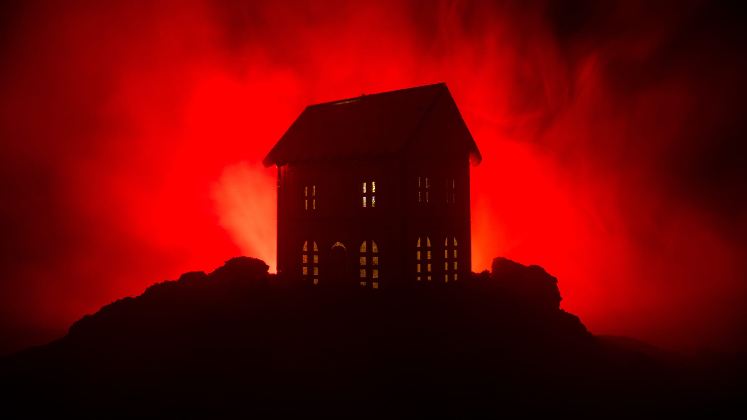 Old house with a Ghost in the forest at night or Abandoned Haunted Horror House in fog. Old mystic building in dead tree forest. Trees at night with moon. Surreal lights. Horror Halloween concept