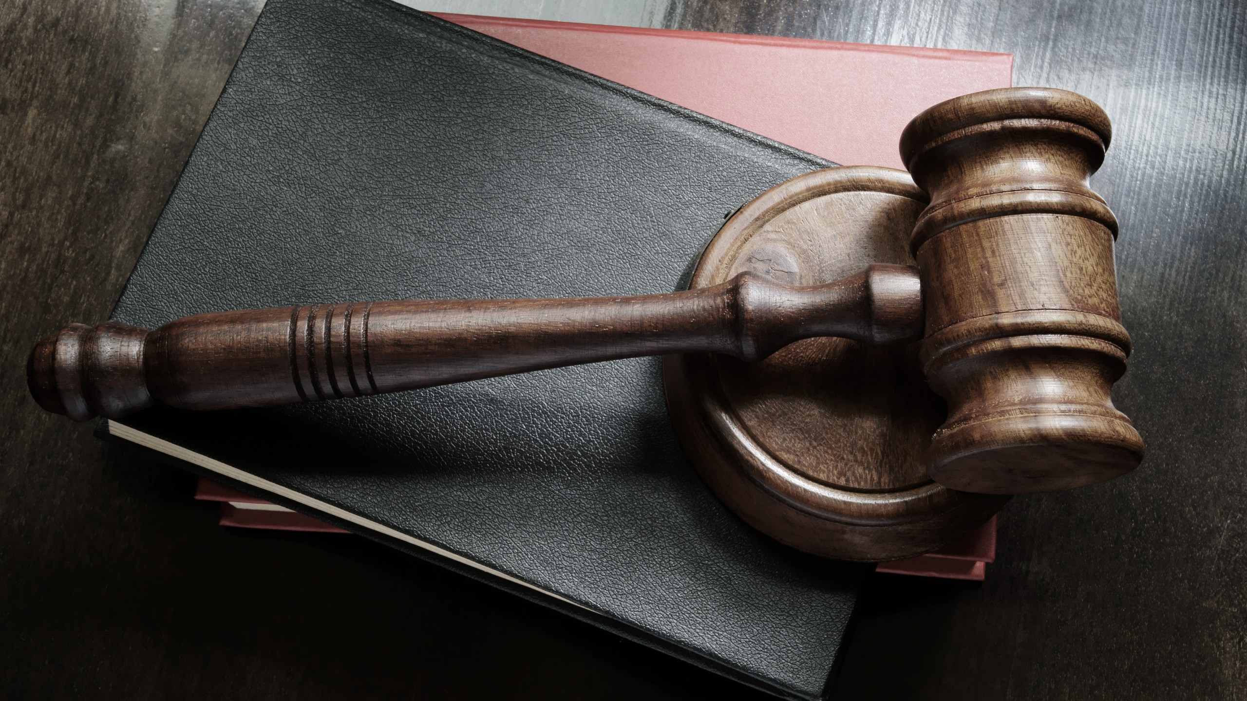 Judge gavel and legal books on wooden table, law concept