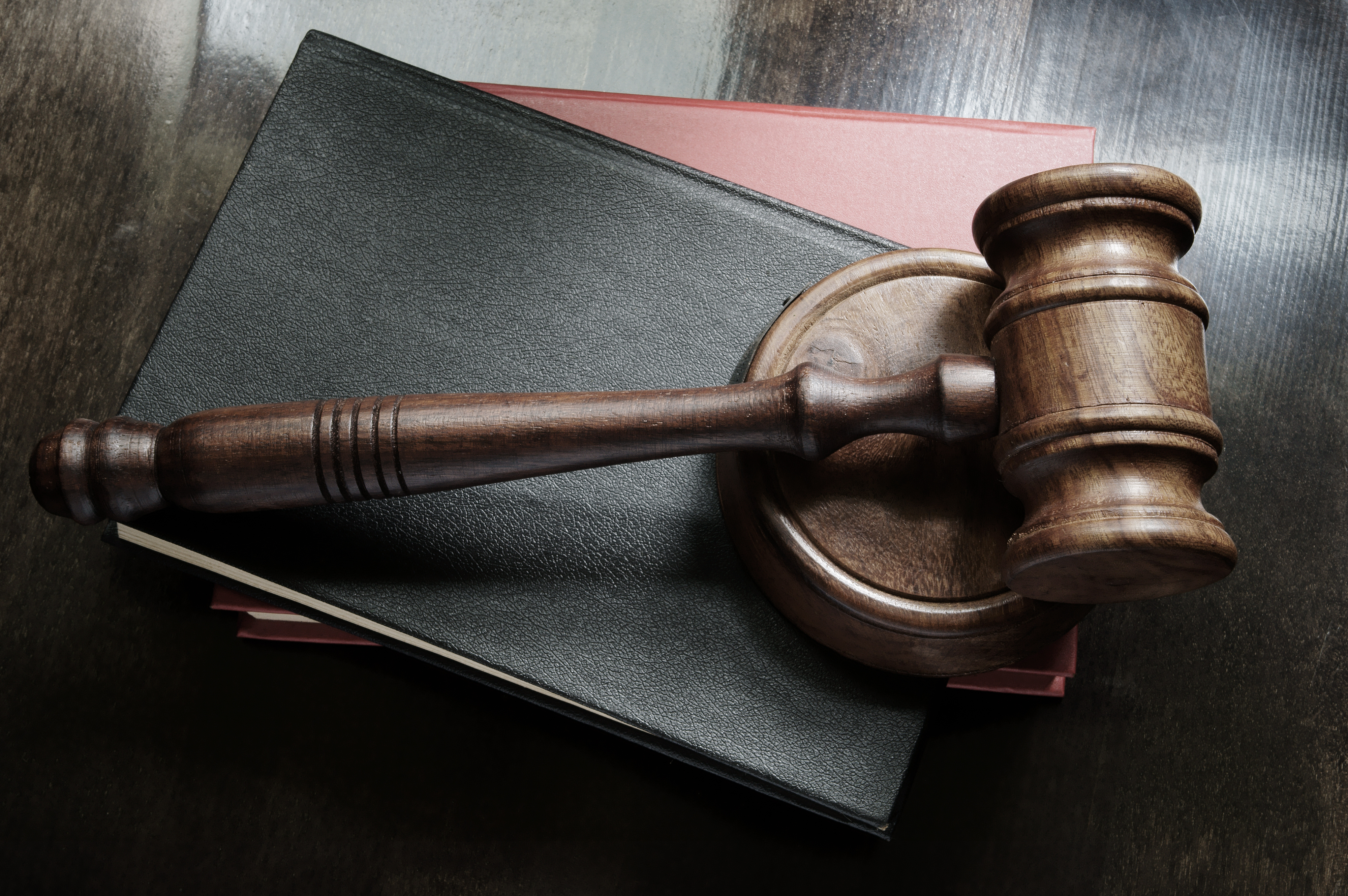 Judge gavel and legal books on wooden table, law concept
