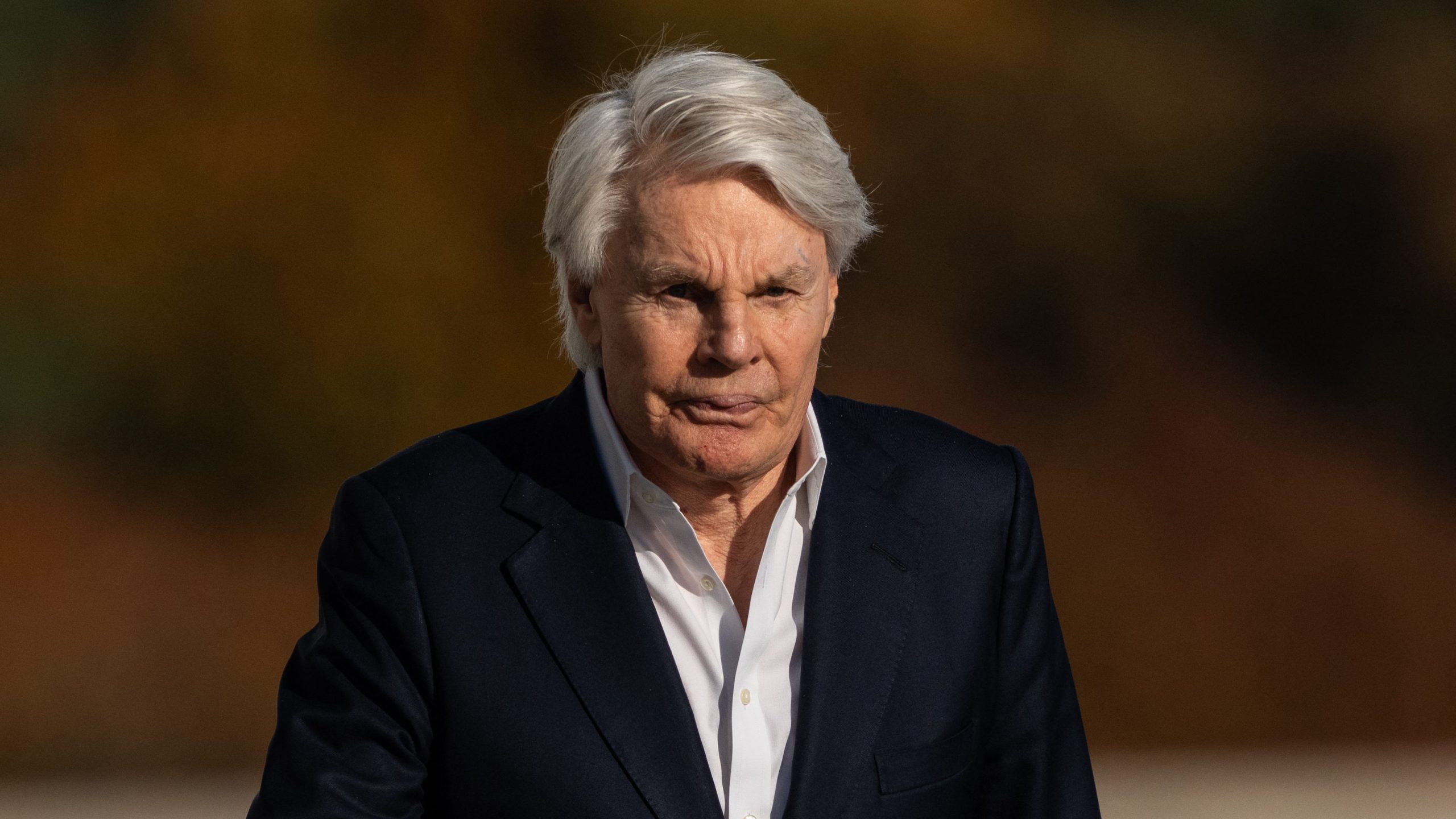 Former CEO of Abercrombie and Fitch, Mike Jeffries, walks out of federal court after his arraignment on charges with the trafficking of male models for sex parties around the world, in Central Islip, New York on October 25, 2024. Jeffries, his partner Matthew Smith and the pair's fixer James Jacobson allegedly used a "casting couch" ploy to groom aspiring male models to attend sex parties at which victims were plied with alcohol and drugs. (Photo by Adam GRAY / AFP) (Photo by ADAM GRAY/AFP via Getty Images)