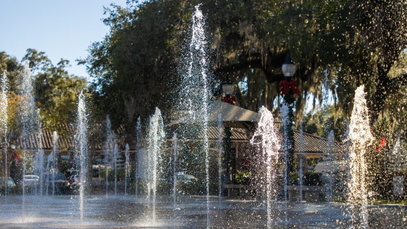 Streams of water spout from the brick ground at a child splash pad late in the day. (Getty Images)