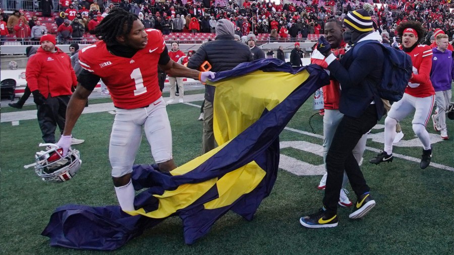 COLUMBUS, OHIO - NOVEMBER 30: Davison Igbinosun #1 of the Ohio State Buckeyes grabs a Michigan flag following his team's defeat against the Michigan Wolverines at Ohio Stadium on November 30, 2024 in Columbus, Ohio. (Photo by Jason Mowry/Getty Images)