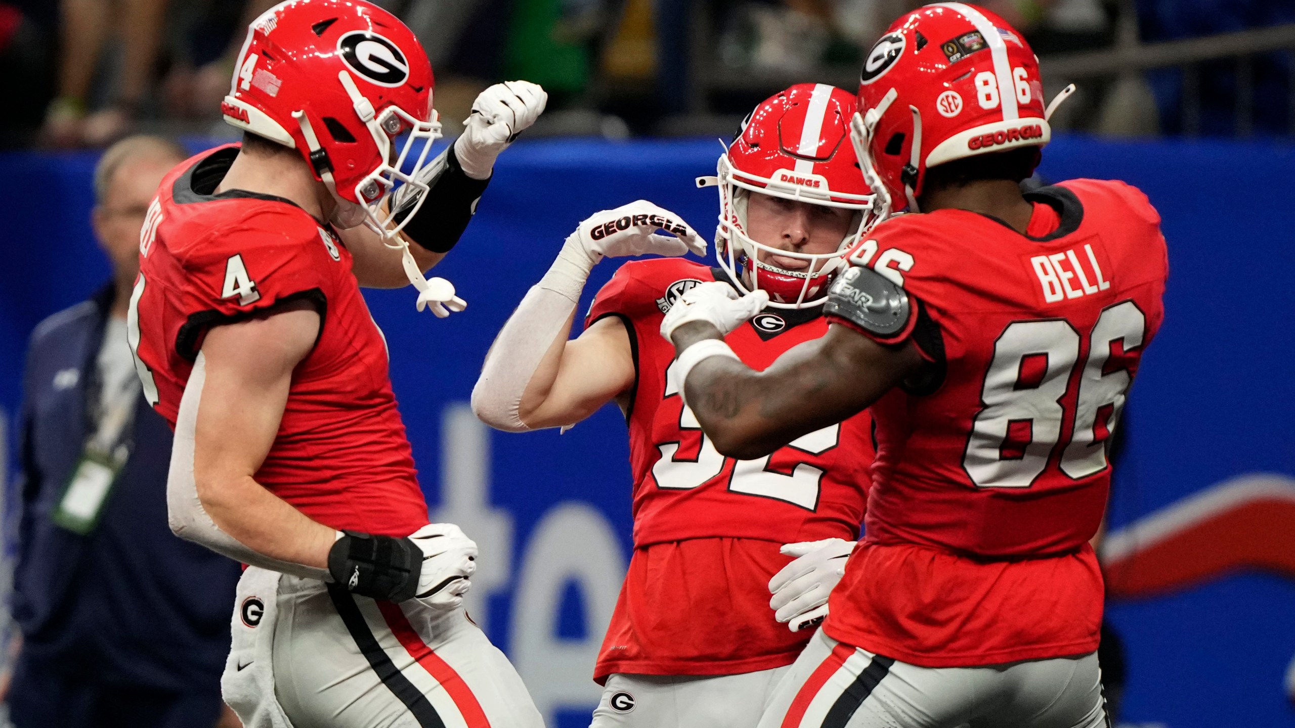 Georgia running back Cash Jones (32) celebrates with teammates Oscar Delp (4) and Dillon Bell (86) after catching a 32-yard touchdown pass during the second half against Notre Dame in the quarterfinals of a College Football Playoff, Thursday, Jan. 2, 2025, in New Orleans. (AP Photo/Gerald Herbert)