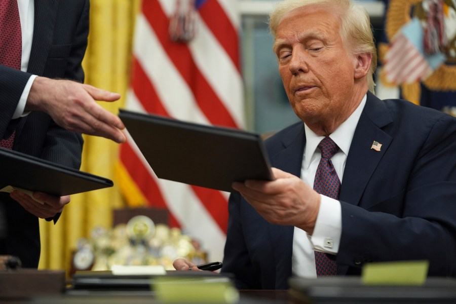 President Donald Trump signs executive orders in the Oval Office of the White House, Monday, Jan. 20, 2025, in Washington. (AP Photo/Evan Vucci)