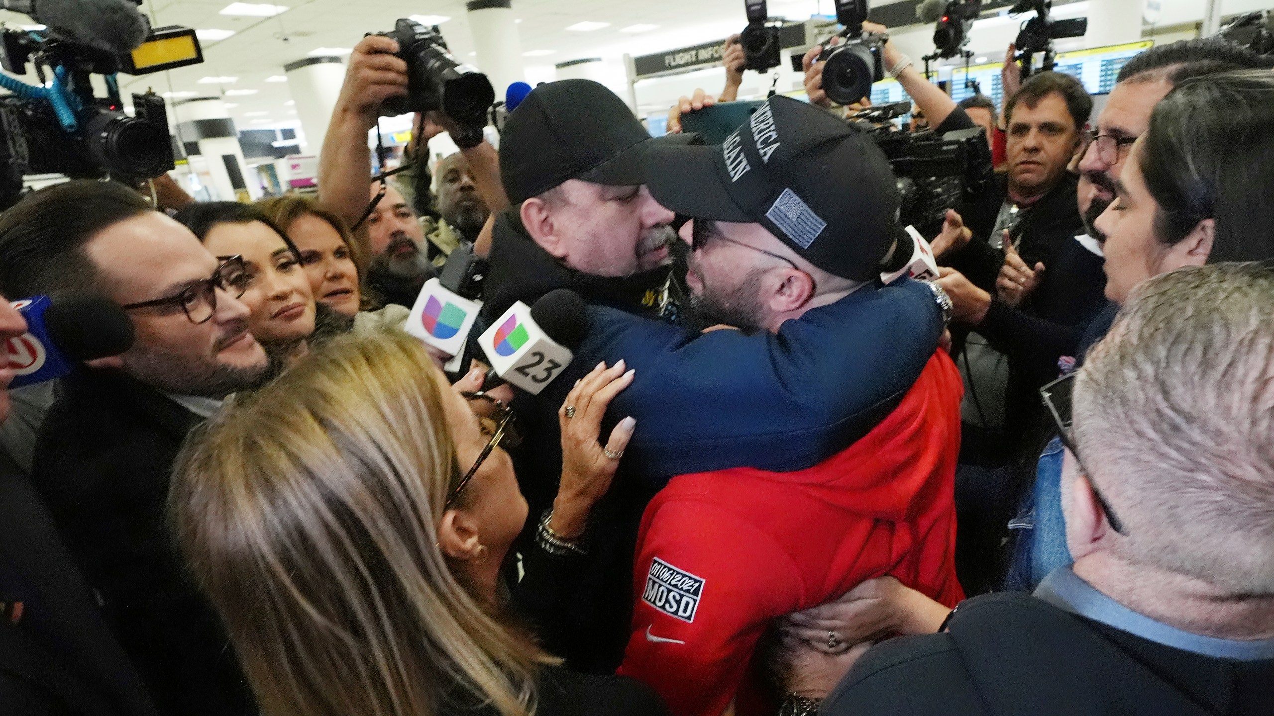 Enrique Tarrio, center right, is hugged by a supporter after arriving at Miami International Airport, Wednesday, Jan. 22, 2025, in Miami. Tarrio was pardoned by President Donald Trump after he was convicted of seditious conspiracy for his role in the January 6 attack on the U.S. Capitol. (AP Photo/Marta Lavandier)