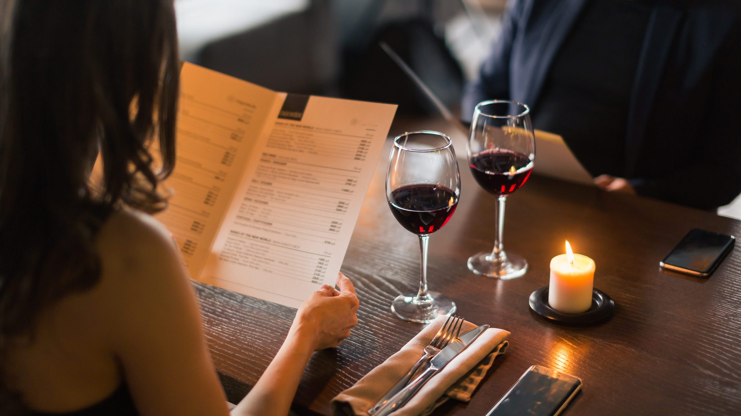 Cheerful couple with menu in a restaurant making order