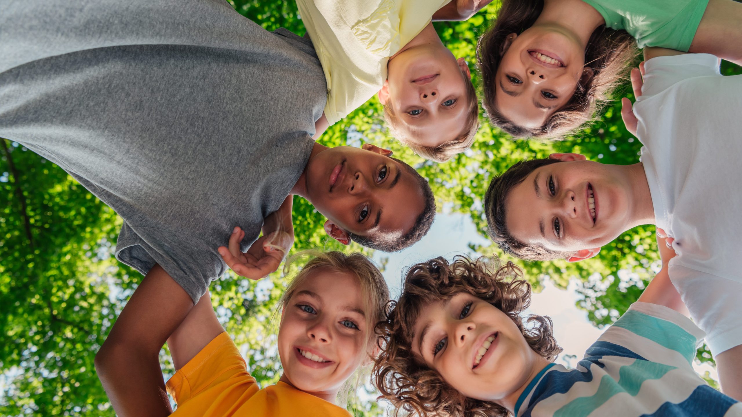 bottom view of happy children looking at camera