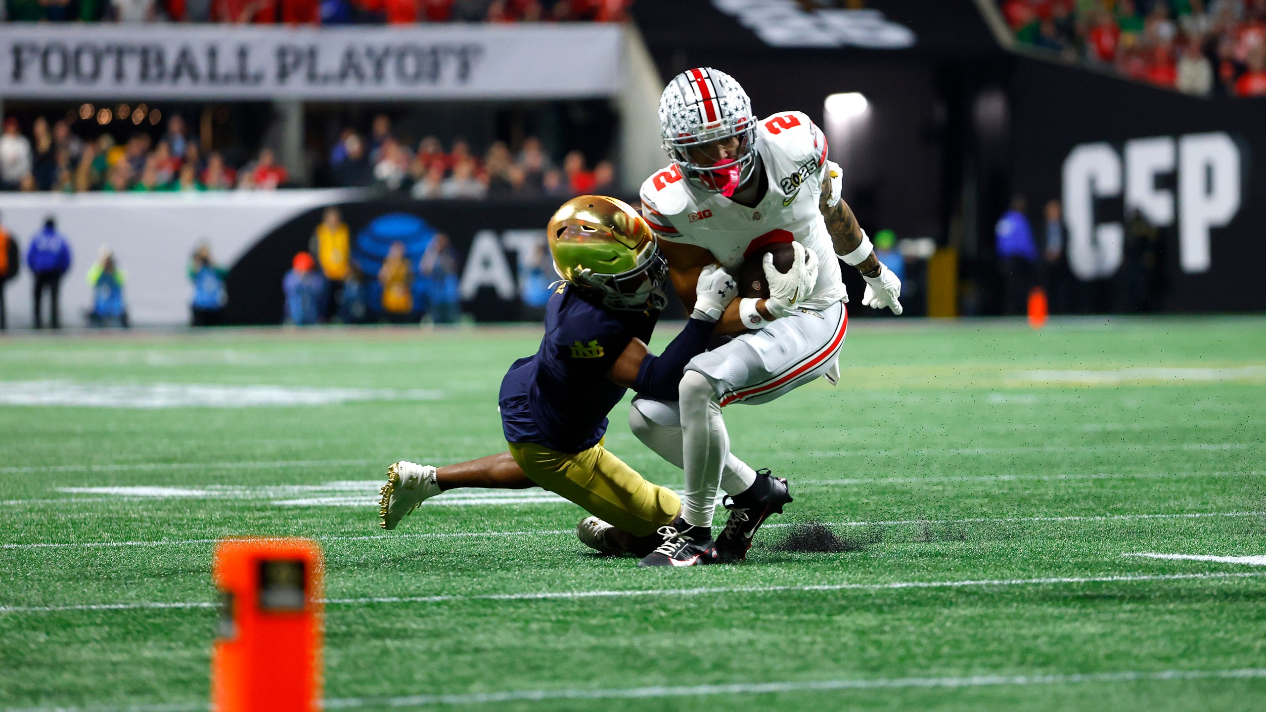 ATLANTA, GEORGIA - JANUARY 20: Emeka Egbuka #2 of the Ohio State Buckeyes is tackled by Jordan Clark #1 of the Notre Dame Fighting Irish during the second quarter in the 2025 CFP National Championship at the Mercedes-Benz Stadium on January 20, 2025 in Atlanta, Georgia. (Photo by Todd Kirkland/Getty Images)