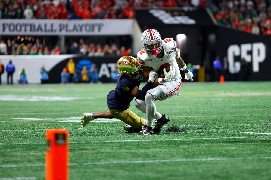ATLANTA, GEORGIA - JANUARY 20: Emeka Egbuka #2 of the Ohio State Buckeyes is tackled by Jordan Clark #1 of the Notre Dame Fighting Irish during the second quarter in the 2025 CFP National Championship at the Mercedes-Benz Stadium on January 20, 2025 in Atlanta, Georgia. (Photo by Todd Kirkland/Getty Images)