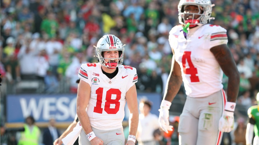 Pasadena, California January 1, 2025-Ohio St. quarterback Will Howard celebrates with his touchdown pass with receiver Jeremiah Smith against Oregon in the second quarter in the quarterfinal of the CFP playoffs at the Rose Bowl Wednesday. (Wally Skalij/Los Angeles Times via Getty Images)