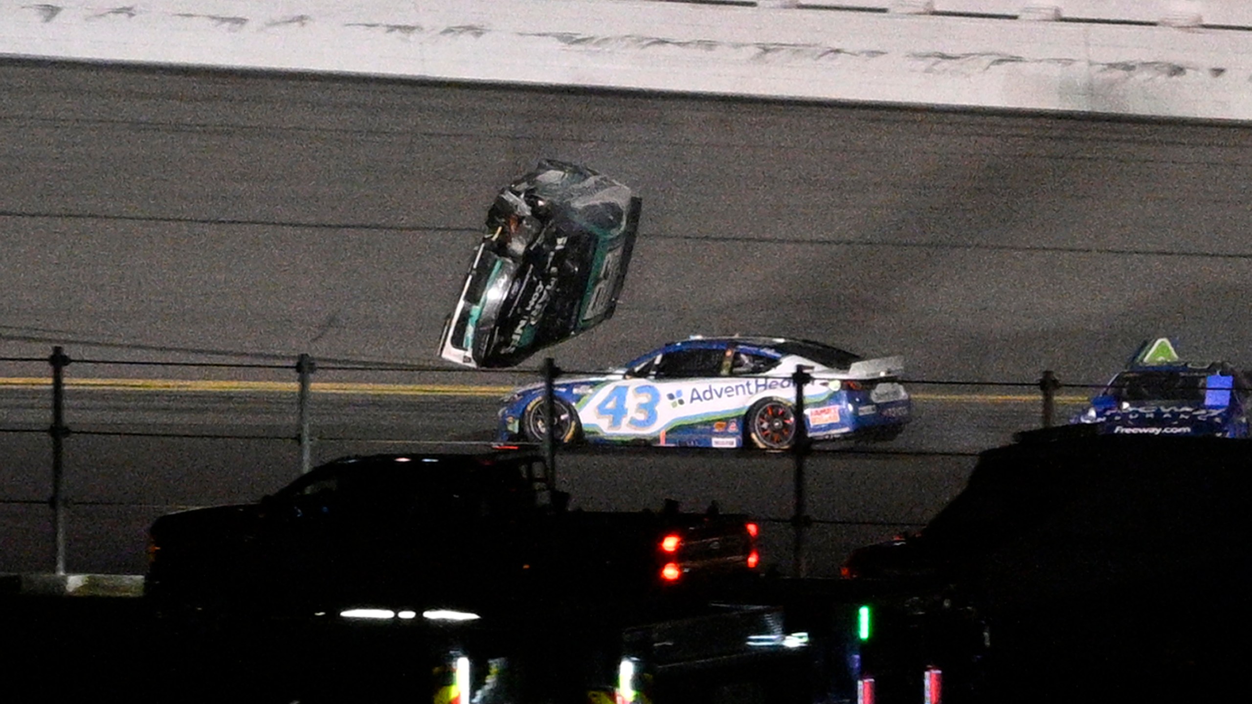 Ryan Preece's car goes airborne in Turn 3 after colliding with Erik Jones (43) during the NASCAR Daytona 500 auto race at Daytona International Speedway, Sunday, Feb. 16, 2025, in Daytona Beach, Fla. (AP Photo/Phelan M. Ebenhack)