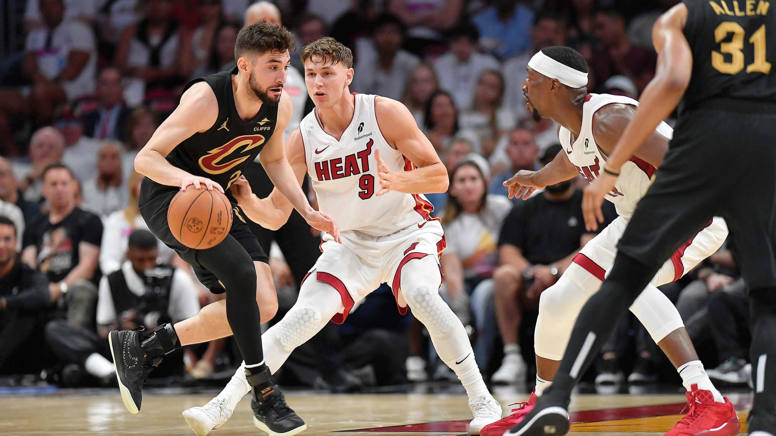 Miami Heat guard Pelle Larsson (9) guards Cleveland Cavaliers guard Ty Jerome during the first half in Game 3 of an NBA basketball first-round playoff series, Saturday, April 26, 2025, in Miami. (AP Photo/Michael Laughlin)