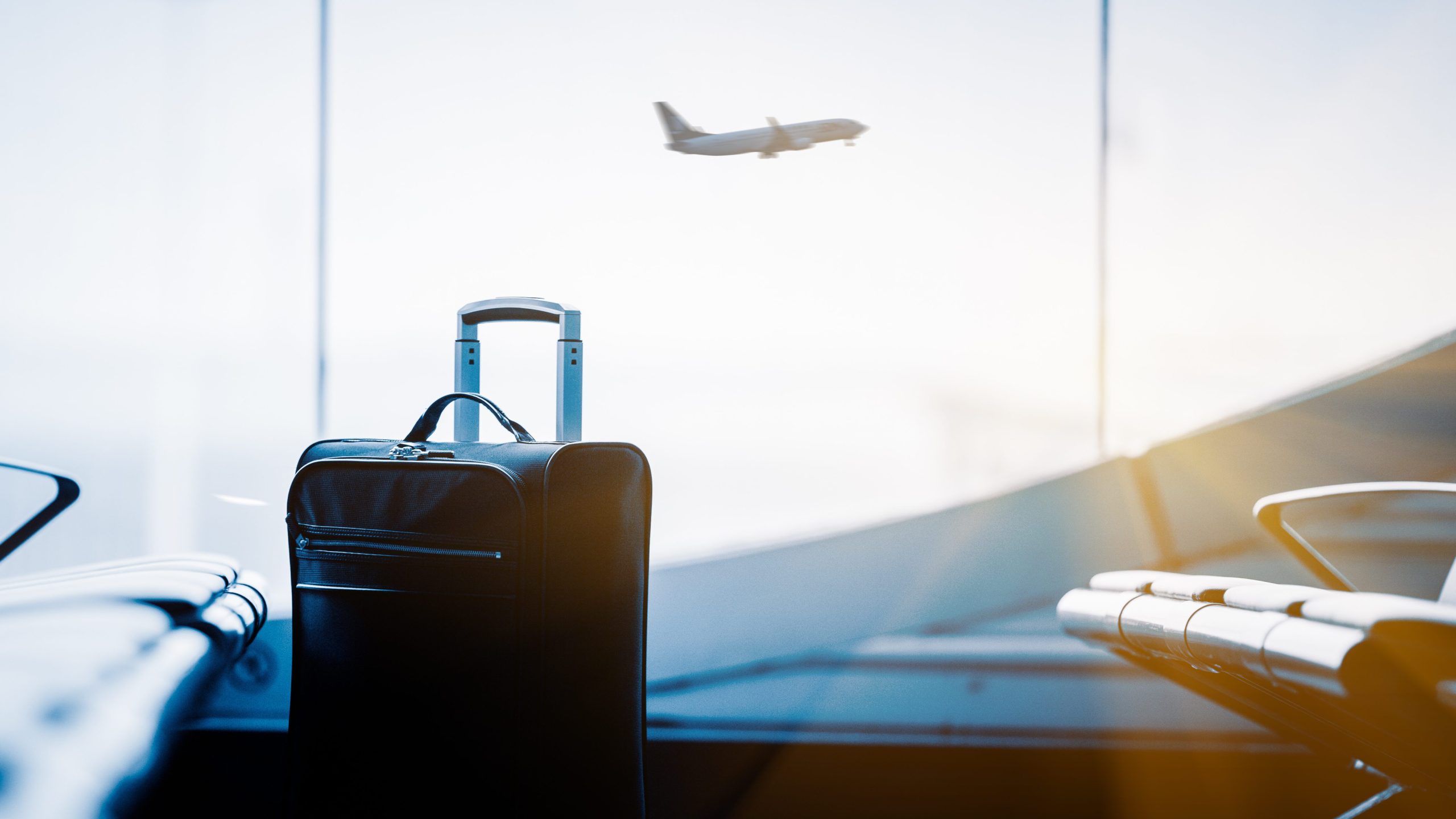 airport interior with flying airplane outside