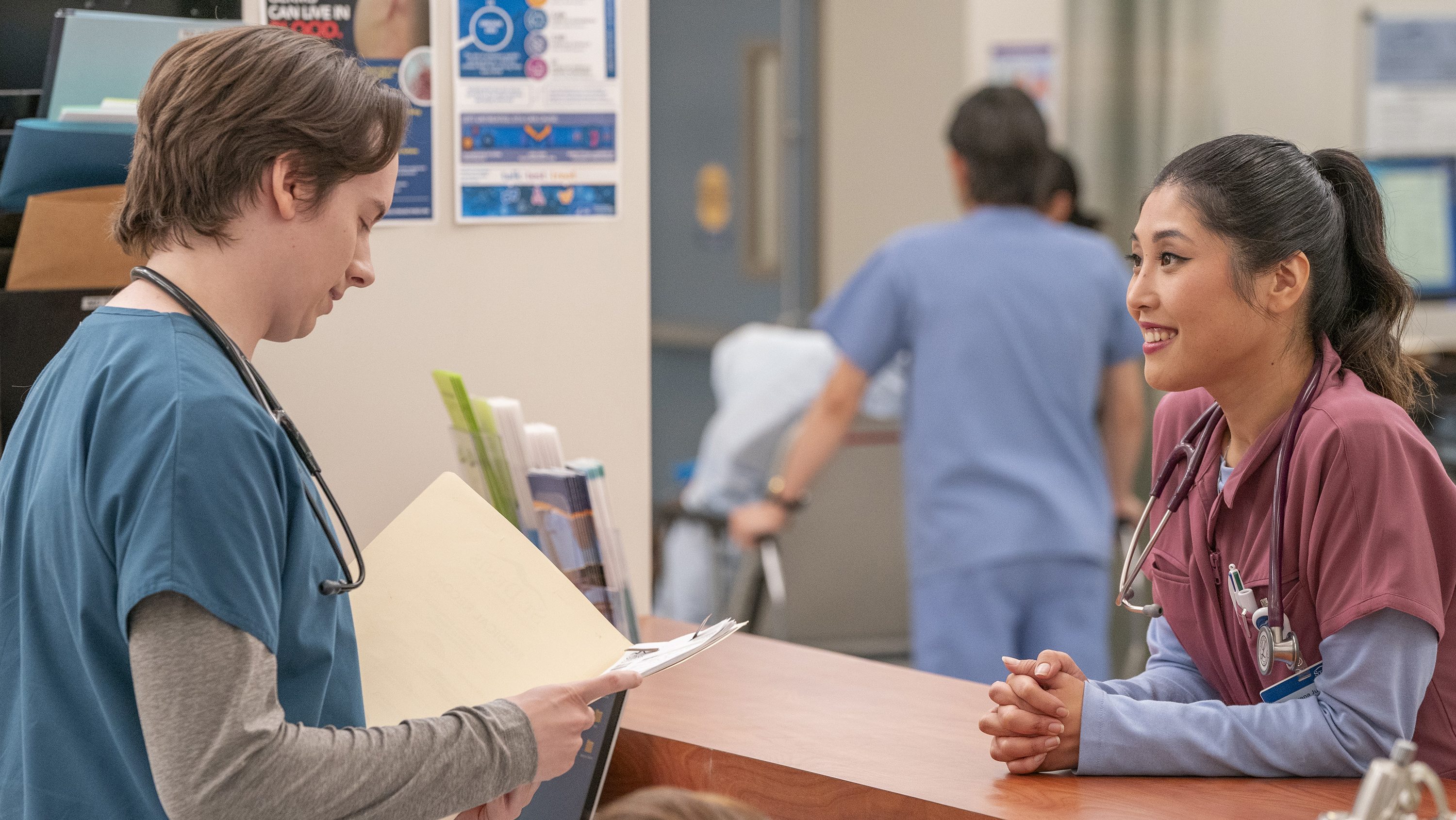 ST. DENIS MEDICAL -- "This Place is Our Everything" Episode 118 -- Pictured: (l-r) Mekki Leeper as Matt, Kahyun Kim as Serena -- (Photo by: Ron Batzdorff/NBC)