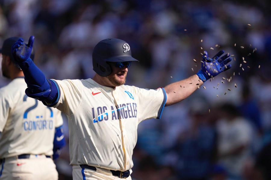 Los Angeles Dodgers' Max Muncy has seeds thrown at him after hitting a three-run home run during the second inning of a baseball game against the New York Yankees, Saturday, May 31, 2025, in Los Angeles. (AP Photo/Mark J. Terrill)