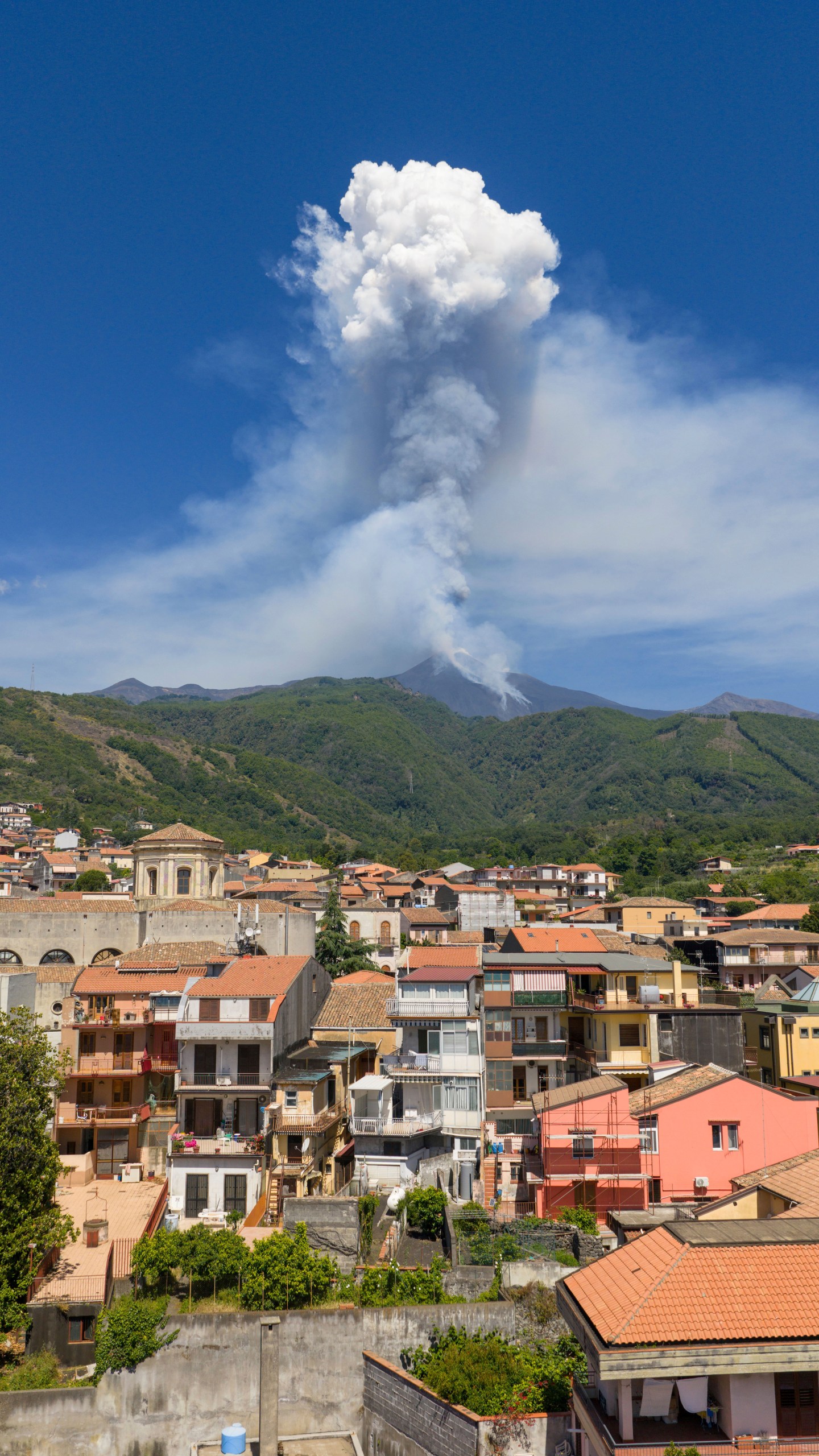 Smoke billows from Mount Etna volcano, seen from the village of Zafferana Etnea, Italy, Monday, June 2, 2025. (AP Photo/Giuseppe Distefano)