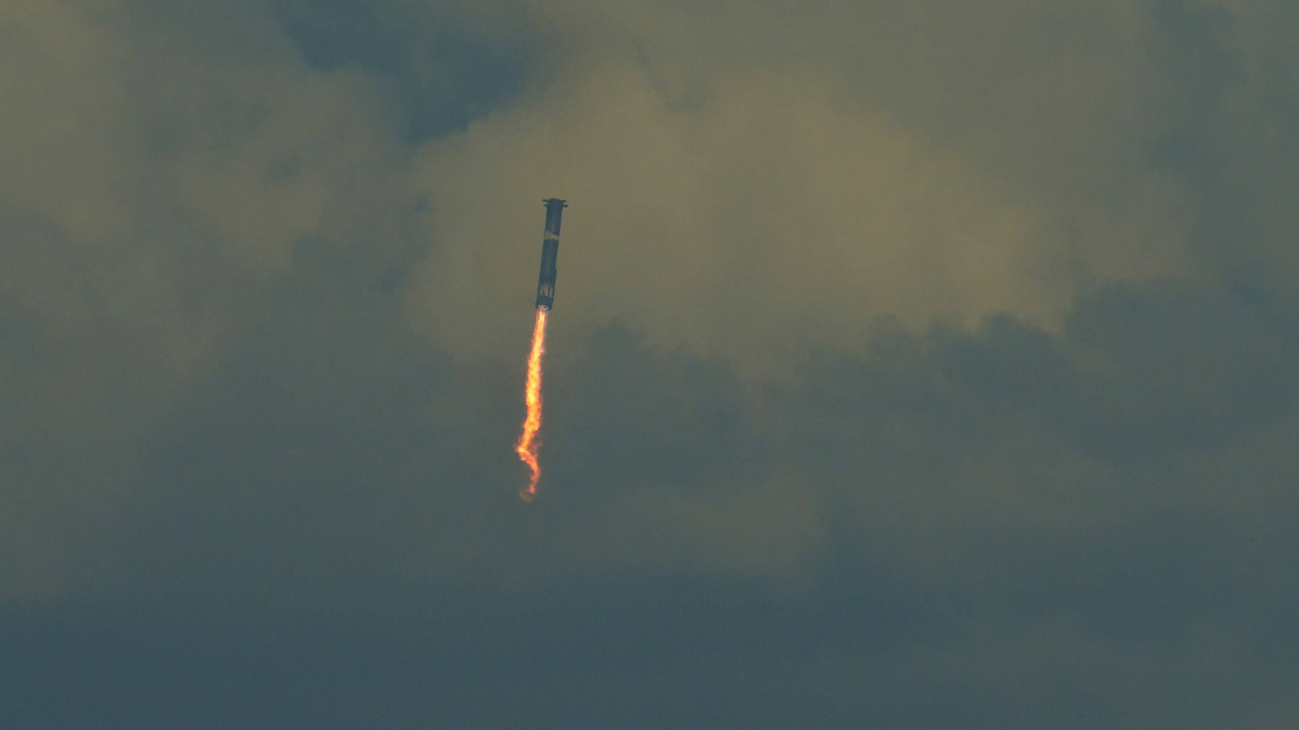 SpaceX's mega rocket booster returns to the gulf during a test flight from Starbase, Texas, Monday, Oct. 13, 2025. (AP Photo/Eric Gay)